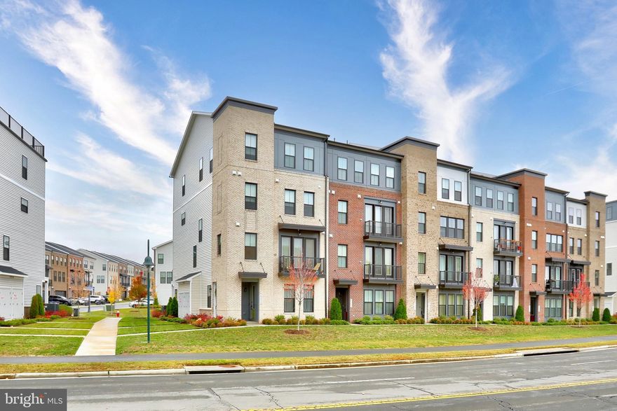 Welcome to modern living at its finest in this stunning 2024-built, four-level end-unit townhouse-style condo located in the heart of Ashburn! Walking distance to the Metro, this home perfectly blends luxury, convenience, and contemporary design with over 2,000+ sq. ft. of beautifully finished living space.

Step inside to an open-concept layout featuring luxury vinyl flooring throughout the main and lower levels, creating a seamless flow ideal for both everyday living and entertaining. The gourmet kitchen is the centerpiece of the home, equipped with granite countertops, a large center island, stainless steel appliances, and ample cabinetry—perfect for hosting gatherings or enjoying a quiet morning coffee.

The expansive primary bedroom suite offers a peaceful retreat with a walk-in closet and a spa-inspired bathroom showcasing floor-to-ceiling tile, a dual-sink vanity with granite counters, and a sleek, modern feel. Two additional generously sized bedrooms share another beautifully upgraded full bath, ensuring comfort for family, guests, or work-from-home needs.

Enjoy the outdoors from your private balcony, a perfect spot to relax and unwind. Being an end-unit, this home is filled with abundant natural light throughout every floor.

Located in a sought-after Ashburn community, just minutes to shopping, dining, parks, and top commuter routes—plus a short walk to the Metro for seamless access to D.C. and beyond—this home offers the best of both lifestyle and location.
