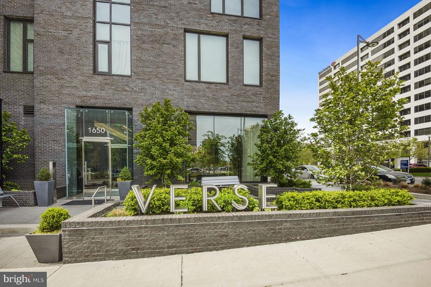 This extraordinary luxury condo in the sky boasts the most spectacular, panoramic distant views in all of McLean!  With over 1800 sq ft of living space occupying a corner on the 22nd floor of the Verse Condominium and an additional 230 sq ft of wrap-around terrace, you have an open floor plan with oversized areas for your living, dining, kitchen, and outdoor activities filled with light from the floor-to-ceiling windows that surround you. The condo has two large bedrooms with en-suite baths, a den, and a powder room. The kitchen is beautifully designed for the serious chef with a gas cooktop and top-of-the-line appliances concealed behind custom Italian cabinetry and a built-in wine cooler. A large quartz island features dramatic waterfall edges. The primary bedroom has a large bathroom filled with Calcutta marble, quartz double sink, and a frameless glass shower features that most people only dream of having, plus a fantastic walk-in closet. The second bedroom is also spacious, has a walk-in closet and a very large en-suite bathroom.  The den is the perfect home office with a great view! The laundry room is equipped with full-size washer and dryer and shelving. Two indoor parking spaces and a storage space complete this unique property. The Verse offers all the luxury amenities you would expect and so much more. There is 24-hour concierge services, beautiful entry lobby, and multiple public spaces for parties or solitary quiet time.  There is also a unique one-acre outdoor Skypark with seating areas, cooking grills, and counter-height refrigerators for outdoor entertainment. In addition to a pool for swimming and lounging in the sun and a first-class fitness facility, the Verse has a pet spa and a guest suite.  The Verse Condominium is located in the heart of the Tysons Boro district, close to the Silver-Line Metro stop and filled with restaurants, shops, movie theaters and its own Whole Foods. Luxury living has been redefined in unit 2201 of the Verse!
