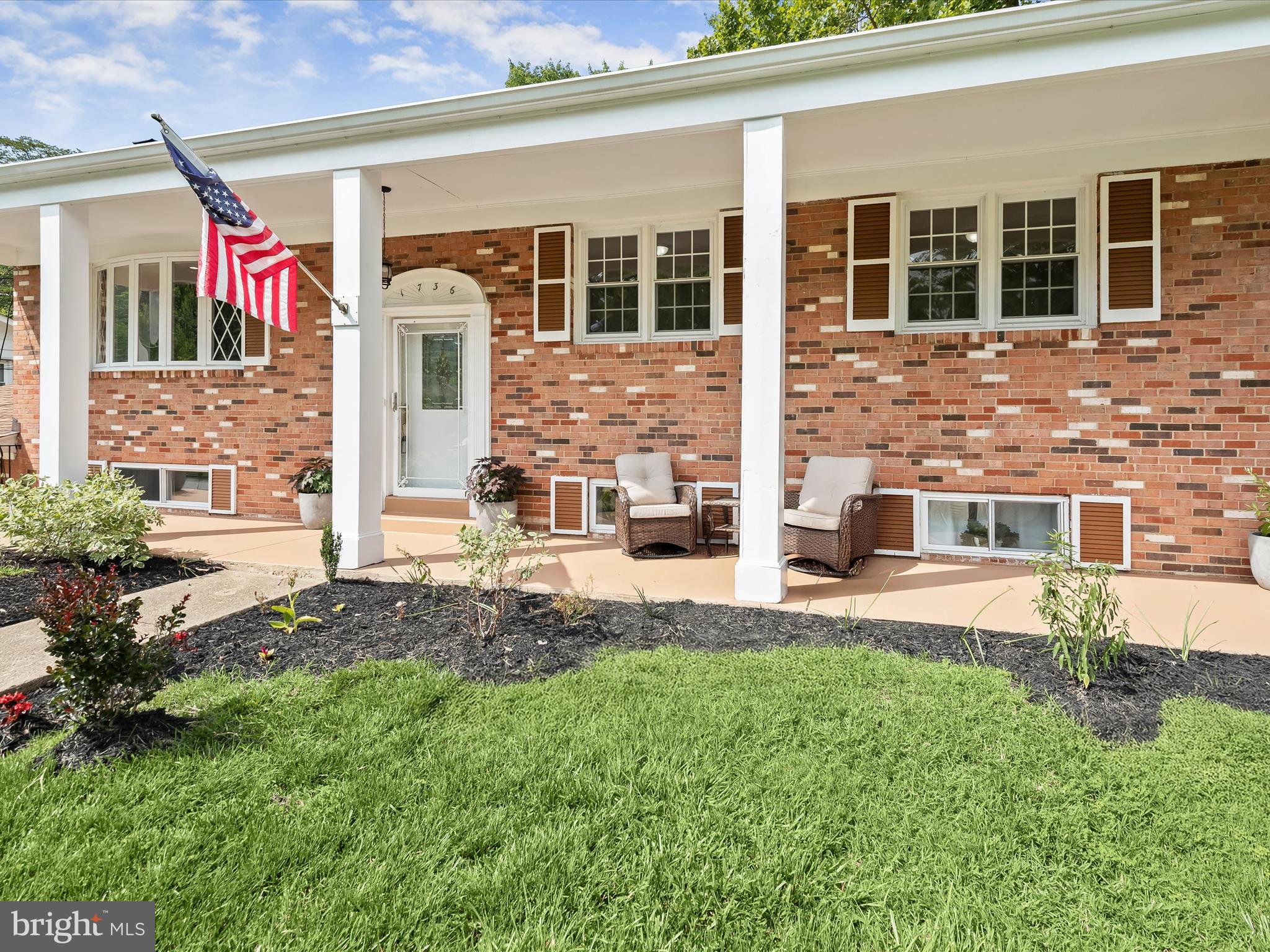 BACK ACTIVE due to Buyer Financing - Step under the covered front porch and into the charming living room, featuring a sunny bay window, crown molding, recessed lighting, original hardwood floors, and a stately brick wood-burning fireplace. The adjoining dining area is ideal for entertaining or enjoying family meals. The updated eat-in kitchen offers granite countertops, a breakfast bar, bright white cabinetry, a modern tile backsplash, stainless steel appliances, gas cooking, and low-maintenance LVP flooring. The main-level primary bedroom features bright windows, hardwood floors, and a beautifully renovated en-suite bath with a sleek walk-in shower. Two additional generously sized bedrooms and a second updated full bath complete this level. Downstairs, the expansive family room showcases a dramatic stone wall with built-in bookcases and cabinetry, a second wood-burning fireplace, and a wet bar with stone surround—perfect for gatherings. This level also includes two more bedrooms, a convenient kitchenette, and a third full bath. Outside, enjoy a spacious deck and a large patio within a fully fenced yard that also offers secure storage. Additional highlights include a one-car garage, and a driveway with ample parking.