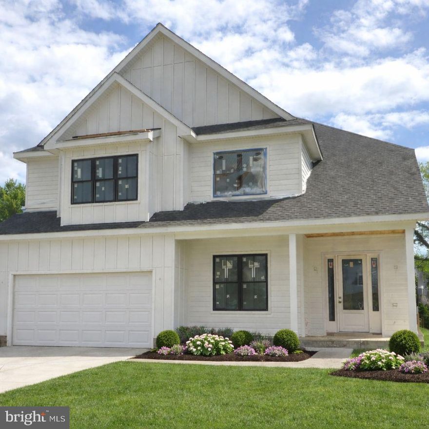 Experience luxury living at its finest in this spectacular new construction on 6th ST N,  in Arlington’s sought-after Brandon Village neighborhood. A spectacular Kane Home Design & Build product! From the grand foyer, you’ll immediately notice the soaring ceilings on all three levels, expansive black-frame windows that flood the home with natural light, and wide-plank white oak floors that set a warm, elevated tone throughout. Designed for both everyday comfort and unforgettable entertaining, the main level features an extraordinary open layout with a showstopping gourmet kitchen—complete with an oversized island with seating, premium stainless steel appliances, an expansive walk-in pantry, and a sunny breakfast nook with access to the rear deck. The adjacent family room offers a cozy gas fireplace, while the separate formal dining room with coffered ceilings is perfect for hosting. A versatile main-level office/bedroom includes a closet and ensuite full bath. You’ll also love the thoughtfully designed mudroom with built-ins, sink, and full-size laundry, offering dual access from the interior and the oversized two-car garage. Upstairs, retreat to an impressive primary suite with cathedral ceiling, sitting area, mini bar, and two walk-in closets. The spa-inspired bath is straight out of a magazine—double vanities, dual showers, and a soaking tub for the ultimate unwind. The secondary bedrooms are beautifully planned: two share a Jack-and-Jill bath, while another enjoys a private full bath. A second upper-level laundry room with cabinetry and counter space adds everyday ease. The walk-out lower level is an entertainer’s dream with a spacious recreation room, large wet bar, dedicated fitness area, and a sixth bedroom with full bath—ideal for guests. Step outside to a fenced backyard with pavers, perfect for relaxing or hosting.