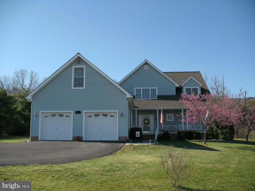 Bright & Beautiful inside & out. Two main level bedrooms, master upstairs with sitting area (sun porch), spacious great room, gas fireplace, newer heat pump with gas backup. Gas tank owned. Fenced back yard, two storage buildings, heated garage with bonus room above. Spectacular Views!