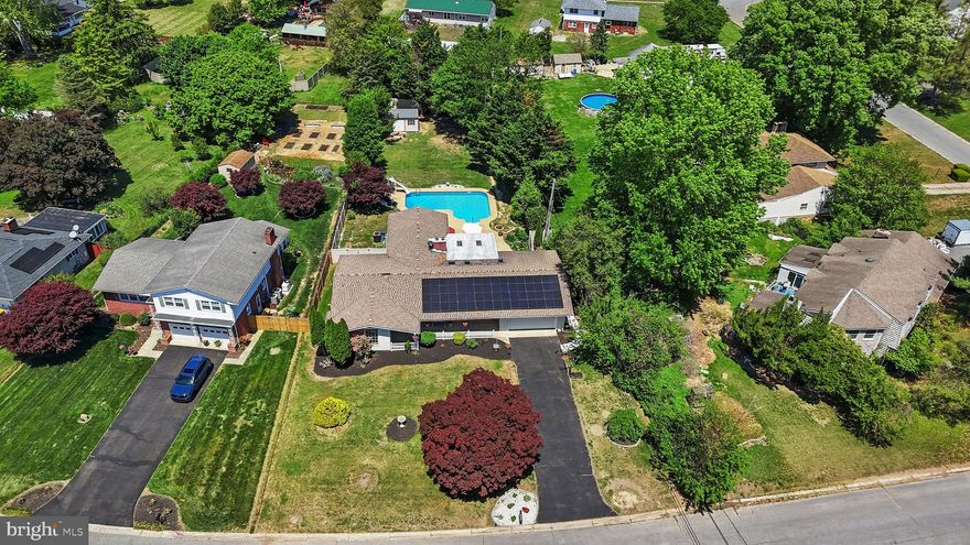 Prepare to SPLASH into Summer!  If you've been waiting for a home that truly has everything, this is it.  Situated in a highly sought-after community with no HOA, this beautifully updated and well-maintained home offers convenient one-level living with a full basement, on a spacious private lot featuring a fully fenced backyard, in-ground heated pool, and two rear decks.   The recently installed solar panels, which are owned - not leased- significantly reduce electric costs with some months resulting in no electric bill.  Upon entry, the home opens to light-filled living areas with beautiful hardwood flooring that flows through the living room, formal dining room, and kitchen, which features stunning granite countertops and stainless steel appliances.  The spacious family room offers a warm and inviting atmosphere, highlighted by a full brick fireplace with a high-efficiency insert, perfect for cozy evenings. Enjoy the large enclosed sunroom with a bar area, wine refrigerator, and half bath, offering an ideal space for entertaining or everyday enjoyment.  The primary suite serves as a relaxing retreat, complete with a spacious ensuite bath featuring a large walk-in shower, jetted tub, and two walk-in closets. Sliding doors provide direct access to a private rear deck and pool, ideal for enjoying morning coffee or unwinding at the end of the day.  Three additional bedrooms - including one bedroom with it's own ensuite bath, and a third full bathroom provide flexibility for multigenerational living or a second primary suite. A spacious laundry room with storage and a freezer is conveniently located just off the kitchen. The partially finished full basement provides endless possibilities, whether you envision a theater room, home gym, office, or recreation space, while still offering plenty of storage. The large attached two car garage and new 10 x 20 shed gives you plenty of room for vehicles and lawn/garden equipment.  Seller recently added a new concrete walkway leading from the driveway to the backyard, a new hot water heater, dishwasher, garbage disposal, windows, flooring, and more.   Enjoy peaceful & private living, in an unbeatable location. Don’t miss your chance to make it yours!