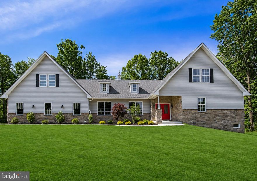 An exquisite 3,200+ sq. ft. luxury custom-built estate located in the highly sought-after Lower Saucon Township. Privately nestled on 2.71 breathtaking acres of flat, manicured grounds bordered by mature trees, this remarkable property offers the perfect blend of elegance, privacy, and nature. Built in 2023 and not occupied until August 2024, the home presents an extraordinary opportunity to own a nearly new luxury residence without the wait for new construction. The sellers are relocating south, making this exceptional home available far sooner than expected. Backing directly to the stunning Sandra Yerger Nature Preserve with over 145 acres of preserved open space, residents can enjoy walking and hiking trails, birdwatching, fishing ponds, cross-country skiing, and dog walking right outside their door. Tucked away on a private cul-de-sac among seven other custom million-dollar estates, this home offers an unmatched lifestyle in one of Pennsylvania’s most desirable school districts. From the moment you step through the grand double-door entry, the craftsmanship and attention to detail are immediately evident. The home showcases extensive custom millwork, crown molding throughout the first floor, impressive 8-inch base moldings, and gorgeous 5-inch true hardwood flooring throughout the entire residence. Every kitchen and bath has been thoughtfully designed with marble or oversized ceramic tile flooring, quartz countertops, double vanities, premium hardware, and elegant glass shower surrounds. The gourmet kitchen is a true centerpiece, featuring high-end Bosch black stainless appliances, custom hardwood cabinetry with soft-close drawers, a striking oversized quartz island, and a designer glass and ceramic backsplash. The open-concept floor plan was designed for both luxurious everyday living and entertaining, offering spacious living and dining areas along with an oversized family room highlighted by soaring 12-foot ceilings, detailed woodwork, and recessed lighting. The first-floor layout is exceptionally versatile, offering a private study or fifth bedroom, an additional guest bedroom, full bath, and an impressive first-floor primary suite complete with an enormous walk-in closet outfitted with premium Closet By Design systems. Upstairs, an elegant oak staircase accented with wrought iron spindles leads to two additional generously sized bedrooms with oversized closets, ceiling fans, and another beautifully appointed full bath. The fully walk-out basement offers nearly 2,000 additional square feet ready to be finished — ideal for an in-law suite, private apartment, home gym, theater, or extended entertaining space. A rare offering of newer luxury construction, acreage, privacy, and natural beauty in Lower Saucon Township — this is truly a place to call home.