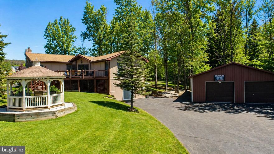 Located in the McHenry Town Center Business District, this property offers a central location with a private feel, surrounded by pines. Zoned Town Center for mixed commercial and residential use and situated on two parcels. The well-maintained two-level home features three bedrooms and three bathrooms, including two primary suites. Updates are found on every level, with luxury vinyl flooring throughout, a gas fireplace, and a lower-level rec room with an expansive wet bar area. Enjoy outdoor living from the large front deck or walk out to the gazebo. Efficient central propane heat and air conditioning, with public water and sewer connections. A 30 x 40 detached garage provides excellent storage, workspace, and paved parking access