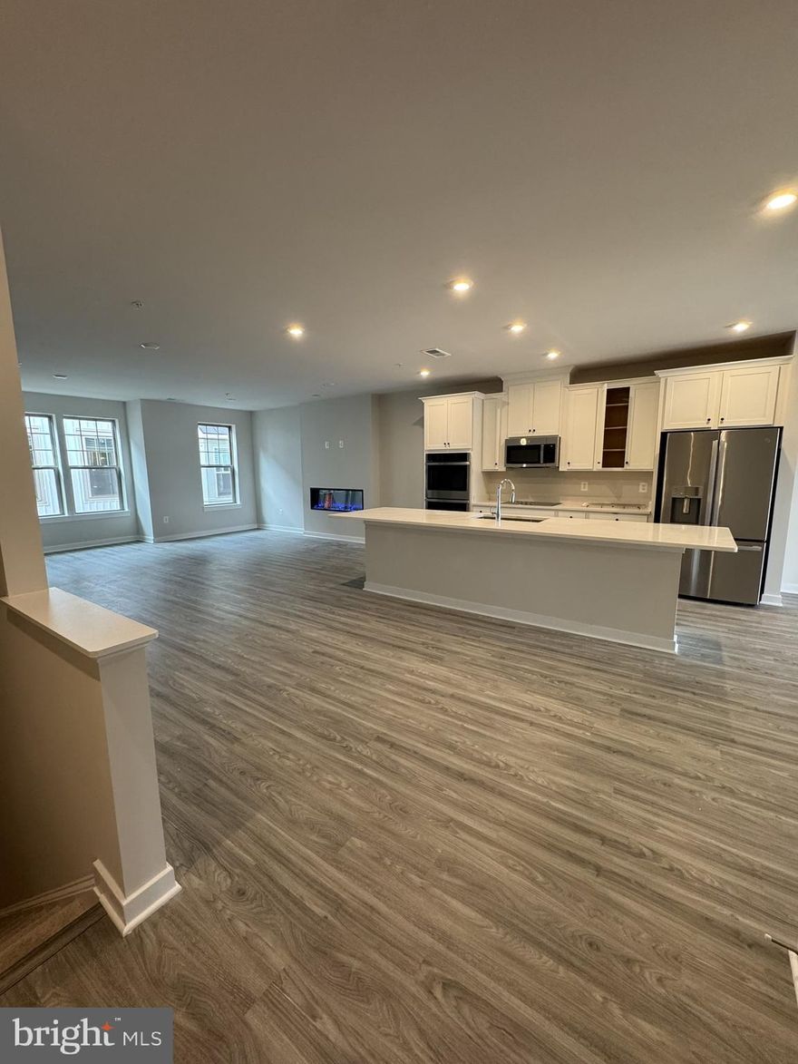 Be the very first to live in this never-occupied-before Stanley Martin condo in the village at Manassas Park community! Located just steps from the brand-new Park Central library, splash pad, farmer’s market, and future restaurants, plus the VRE station—all within a 5-minute walk! This beautiful Julianne floorplan features an expansive 2400 sq/ft it on just 2 levels. Step into a contemporary open-concept layout with a gourmet kitchen featuring a massive frost white quartz island and sleek stainless steel appliances, including WiFi-enabled double ovens! Enjoy three generously sized bedrooms plus a versatile office/study. Relax in the expansive living room by the cozy gas fireplace, or sip your morning coffee on your private deck. Owner's Ensuite bath has dual quartz top vanities and a walk-in shower! Owner's suite has not one but TWO walk in closets! Washer and dryer in unit. One car garage with a full driveway for a 2nd vehicle. You are minutes from Old Town Manassas, shopping, dining, Liberia Ave shopping corridor and entertainment (2 Silos!). Take advantage of the Virginia Railway Express Station to cut your commute you to Washington D.C. Quick access to Route 28 and Route 66. Nearby recreational options include Bull Run Regional Park, Prince William County Fairgrounds, Splash Down Waterpark.