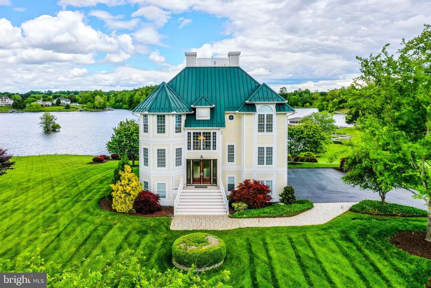 Step into luxury at this one-of-a-kind waterfront oasis in the heart of Lake Anna.  Set on a gorgeous waterfront lot behind a gated entrance and lush green vegetation, this 5 bedroom, 5 bathroom masterpiece sits along 150 feet of serene shoreline, with its own private beach, enormous two-slip custom boathouse, and professionally manicured landscaping that will take your breath away.  Designed to perfection, the main floor is ideal for spending quality time with family and friends, with its soaring twenty-foot ceilings, floor-to-ceiling windows with remote-controlled blinds showcasing glorious water views, and a warm double-sided stone fireplace, all of which transition seamlessly into your massive chef’s kitchen, featuring luxurious granite countertops, large island, massive stainless steel fridge and gas stove top.  The main floor also offers a primary bedroom suite, guest bedroom accommodations and laundry room.  You’ll never want to leave the exquisitely designed primary suite on the second level, which features your own private balcony overlooking the lake and masterful landscaping, stunning tray ceilings, luxurious crown molding and a wet bar.  The spa-like en-suite bathroom has a double-sided fireplace, jetted tub, tiled walk-in shower, double vanity and oversized walk-in closet.  The second level also offers an additional spacious guest bedroom and full bath.  The walkout basement is the epitome of entertainment, with a large recreation/ family room, walkout exit to the water, guest bedroom and full bath with gorgeous tile floors, tiled shower and granite countertops.  Out back, enjoy sunsets and take-in unobstructed views of the lake, incredible landscaping nurtured by a custom lake-fed irrigation system, and extensive hardscaping from above on your massive maintenance-free deck that extends from the rear of the house.  Stroll down to the water’s edge and unwind in your large boathouse, featuring composite decking, a huge screened-in patio with gorgeous tongue-in-groove ceilings, recessed lighting, two boat slips with electric lifts and a spacious storage room for your water toys.  Tankless hot water heater, water softener system, and surround sound speaker system throughout the home.  Talk about a great location; this oasis is a two-minute drive from Tim’s At Lake Anna, arguably the most popular waterfront bar/grill at Lake Anna.  INVESTORS: Fox Business recently named Lake Anna THE TOP “beach” vacation investment location in the entire nation - this lakefront paradise would make an incredibly lucrative investment asset and it comes fully furnished!