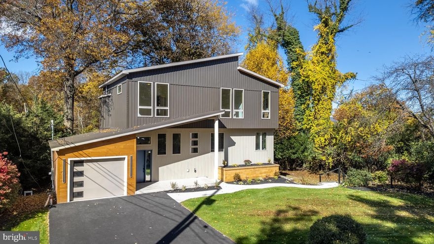 Tucked at the end of a quiet cul-de-sac, 435 Ferguson Avenue enjoys an unbeatable College Heights location with direct access to the Arboretum grounds and tailgating fields. Originally built in 1952 and completely reimagined and expanded in 2025, this 3,036-square-foot residence seamlessly blends timeless mid-century architecture with contemporary craftsmanship and modern convenience. Set on a .33-acre lot bordering the Arboretum, the home features 4 bedrooms and 4.5 bathrooms, solid red oak flooring throughout, and custom white oak cabinetry hand-built by local Amish craftsmen. Expansive floor-to-ceiling windows framed in white oak fill the home with natural light and showcase picturesque backyard views, while the kitchen’s mid-century inspired design includes zellige tile, a waterfall quartz countertop, sleek appliances, and a spacious pantry. Upstairs, three guest suites complement the primary suite, which captures serene treetop views, and each bathroom offers floor-to-ceiling tile, custom vanities, and terrazzo floors with radiant heat—even in the showers. The garden-level recreation room, ideal for entertaining, includes direct backyard access and a full entertainment kitchen with a dishwasher, beverage fridge, wine cooler, undercounter fridge/freezer, microwave, and ice maker. Outdoor living is equally refined with a spacious composite deck off the main level and a paver patio on the garden level, perfect for gatherings or quiet relaxation. Located just 200 yards from Sunset Park and only a few blocks from Penn State’s campus, 435 Ferguson Avenue is a rare retreat in the heart of Happy Valley.