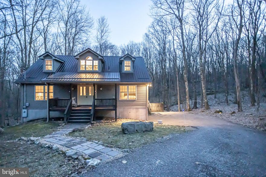 WELCOME TO *CREEKSIDE CABIN* This 4 Bedroom 2 1/2 Bath Cape Cod is nestled on two lots and a short distance to Alpine Lake & the Boat House. Gorgeous Hardwood floors on the main level; Spacious Primary En-Suite also on the main level includes a spacious closet, attached full bath. The 2nd Bedroom can be used as an office if working from home Fiber Optics Internet available. Spacious GREAT ROOM with a Gas Fireplace to cozy up to on those chilly evenings. The kitchen includes a center island with plenty of cabinets and room to entertain, Open floor concept. Relax on the covered back screened-in porch or sit by the firepit & enjoy listening to the running creek & take in the Beauty all around you! This property BACKS TO GREEN SPACE which offers you PLENTY OF PRIVACY & BEAUTIFUL Surroundings. MOVE-IN CONDITION, metal roof installed in 2021 along with  Appliances.  Alpine Lake Amenities Inc: HEATED Indoor Pool, Exercise Room, Game Room, Restaurant/Lounge, paved roads, sandy beach, boat house/boat ramp, tennis/basketball/pickle ball court, hiking/biking trails, 24/7 Security, playground area, 18 HOLE GOLF Course, miniature golf, kayaking, canoeing, paddleboat & GREAT FISHING! IS THIS THE PROPERTY FOR YOU?  CALL TODAY to set up a viewing of this SPECTACULAR Property...