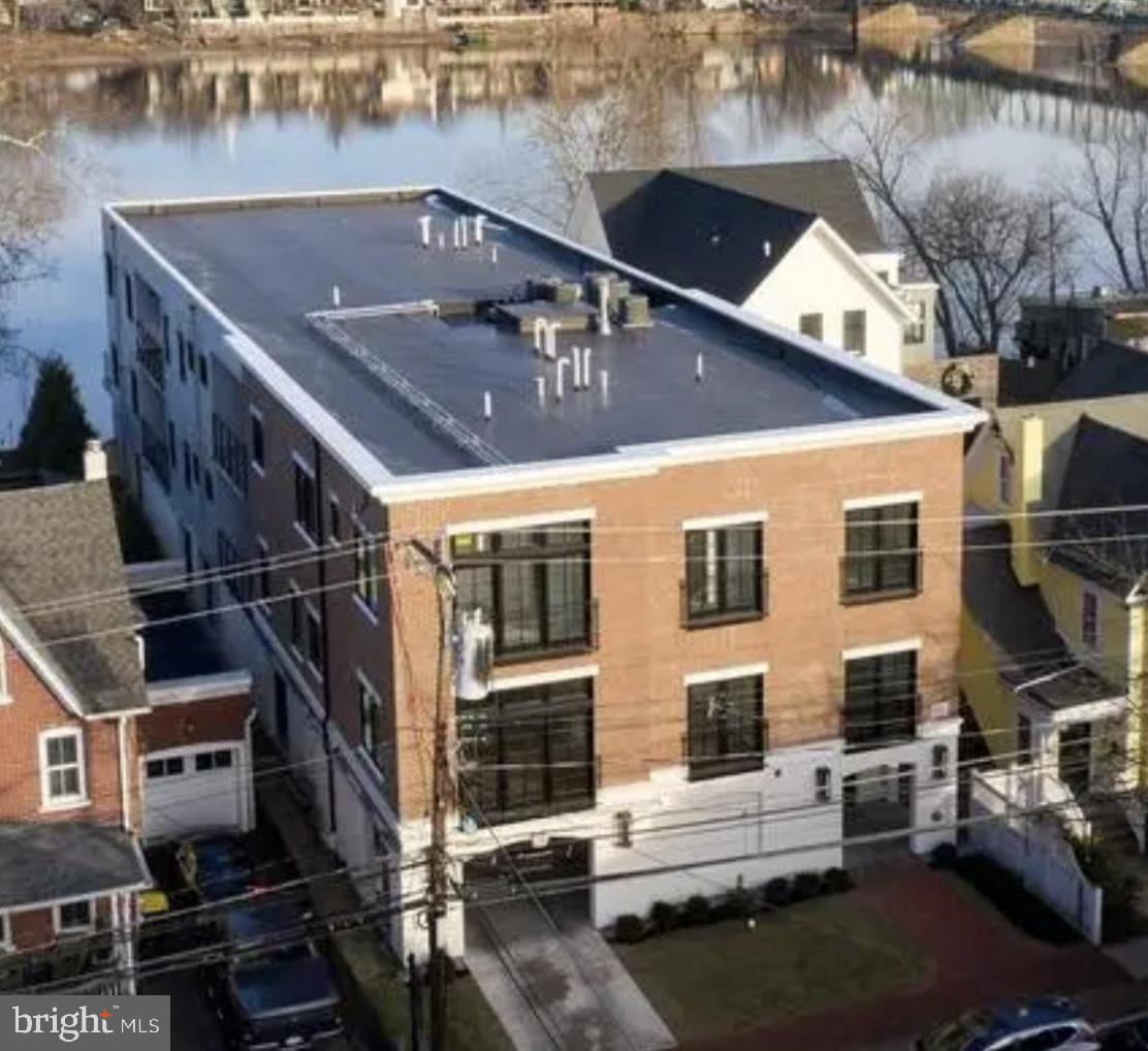 RiversEdge offers 4 sophisticated, luxury Residences providing carefree living at its finest in the heart of New Hope. Condo C is the top floor, street front residence with river views from the northern side balcony and views of the New Hope Lambertville bridge. This 3 Bedroom 2 1/2 bath condo is beautifully appointed with over 2500 sq ft of living space and all the amenities one could wish to have in a luxury home. Enter the stunning residence with nearly 10 ft ceilings and hardwood floors thorough out. The Gourmet kitchen features custom white cabinetry, quartz counters, high end stainless steel appliance package, built in microwave and wine refrigerator. Attached is the Formal dining area with river views and a side balcony perfect for morning coffee or evening relaxing. The large Family room has a cozy gas Fireplace. The luxurious Master Suite has an opulent Master bath with glass shower and soaking tub. There are two additional bedrooms sharing a full bath and an office. The Gorgeous expansive riverfront patio has breathtaking views and is perfect for relaxing or entertaining with the multi levels, firepit, and stairs for access to the river. There is a dock with boat slip. The property has a secure gated parking garage with 2 designated spaces for each condo and individual storage units. Located within walking distance to all the charm, history, shops, restaurants and nightlife New Hope has to offer!
