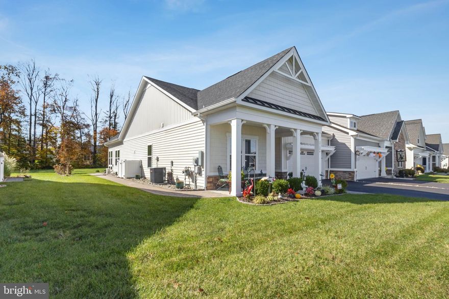 Welcome to low-maintenance, resort-style living at 27284 Shipwreck Dr in the coveted Lighthouse Lakes community of Selbyville, DE. This stunning single-level home is designed for modern living, featuring an open-concept living room with high ceilings that flows seamlessly into the gourmet kitchen, which boasts an inviting island, elegant granite counters, and upgraded stainless steel appliances. Relax and entertain year-round in the upgraded sunroom, which provides direct access to the private paver patio and a spacious backyard that backs up to tranquil trees. The luxurious primary suite is a true retreat, offering a large walk-in closet and a spa-like en-suite bathroom with a dual sink vanity and stall shower complete with dual shower heads. Two additional bedrooms and a hall bathroom ensure ample space for family or guests, while the charming exterior—featuring a covered front porch with columns, a paved driveway, and an attached front garage with an eyebrow pergola—offers excellent curb appeal. As a resident of Lighthouse Lakes, you'll enjoy a wealth of amenities, including an outdoor pool, splash pad, a clubhouse with a fitness center, putting green, tennis and pickleball courts, and a kayak launch via the community's dock. This prime coastal location puts you just a short 15-minute drive from the beaches of Fenwick Island and Ocean City, MD, with easy access to shopping, dining, and local attractions, making it the perfect blend of seaside escape and everyday convenience.