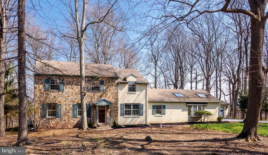 Welcome to 1116 Tinker Hill Lane, a wonderful four-bedroom center hall colonial set on a private 2.3-acre lot in the heart of Charlestown. This home offers a rare combination of privacy and convenience, just minutes from the shops and restaurants of Malvern, Phoenixville, and the Main Line—and just a few doors down from the scenic Thompson Trail. The formal entry hall opens to a gracious living room on the left and a classic dining room on the right, complete with chair rail detailing—an ideal setting for everyday meals and holiday gatherings. The kitchen features tiled countertops, a double oven, a double sink, and plenty of raised panel cabinetry. The kitchen is open to a spacious dining area, highlighted by a classic brick fireplace flanked by built-in bookshelves. The dining area opens to the screened-in porch with a timeless brick floor, creating an easy connection to the outdoors. Just off the kitchen are a well-placed powder room, laundry area, and a hallway leading to the fabulous family room. This space offers vaulted ceilings, skylights, exposed beams, and a stone fireplace as its focal point, along with a functional wet bar, ideal for entertaining. A doorway from this hallway provides access to the deck. A private home office is tucked along this hallway, providing a quiet and flexible workspace. Upstairs, the owner’s suite includes a spacious tiled bathroom with a skylight, a jetted soaking tub, a large walk-in closet, and an additional closet. Three additional bedrooms are served by a full hall bath. The basement offers two expansive rooms with tremendous potential. One is semi-finished with painted block walls, a painted floor, and a wine cellar/closet. The second is a large unfinished space with workbenches and Bilco door access to the side yard. The outdoor areas of this home are truly exceptional. The brick patio and wood deck overlook the rear grounds, the ideal setting for relaxing, entertaining, grilling, and dining alfresco. A three-car garage provides tremendous storage space and everyday convenience. Hardwood floors, tremendous storage space, recessed lighting, a classic floor plan, and solid construction, along with a propane-powered generator, all come together to make 1116 Tinker Hill Lane a very special place to call home. This is a tremendous opportunity to own a classic home on two-plus beautiful acres with mature plantings and shade trees. This is the one you’ve been hoping would come on the market. Welcome home!