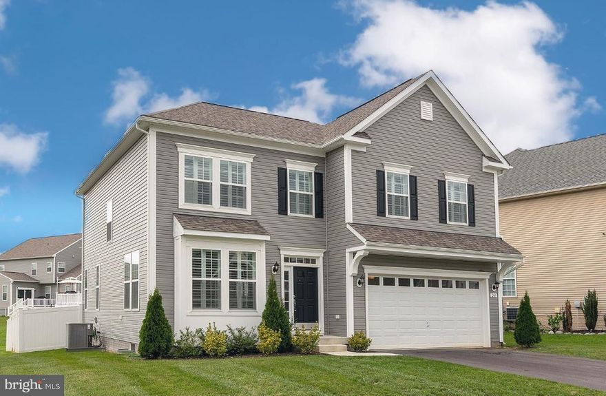 BETTER THAN NEW … this 2 year young spacious colonial offers over 4000 finished square feet! Seller opted for all of the custom upgrades when building … morning room and great room extension, custom gourmet kitchen, recessed lighting and LVP flooring throughout main living areas, crown molding, built-in cabinetry in laundry and mud room, 3 tiled baths and finished basement with office/den/5th bedroom! 16k plantation shutters added throughout this gorgeous home. Vaulted ceilings in dining area, Quartz counters and stainless steel kitchen appliances including double ovens, and microwave convection oven. Huge owners suite boasts adjoining bath with separate shower and soaking tub, double sink vanity. The extra 3 bedrooms are super spacious and some offer walk in closets. Large upper landing joins custom stained staircase with wrought iron railing. Spacious Trex deck overlooks vinyl fenced in rear yard. Every special added option has been completed and ready to be enjoyed by its new owners in sought after Martinsburg Station!