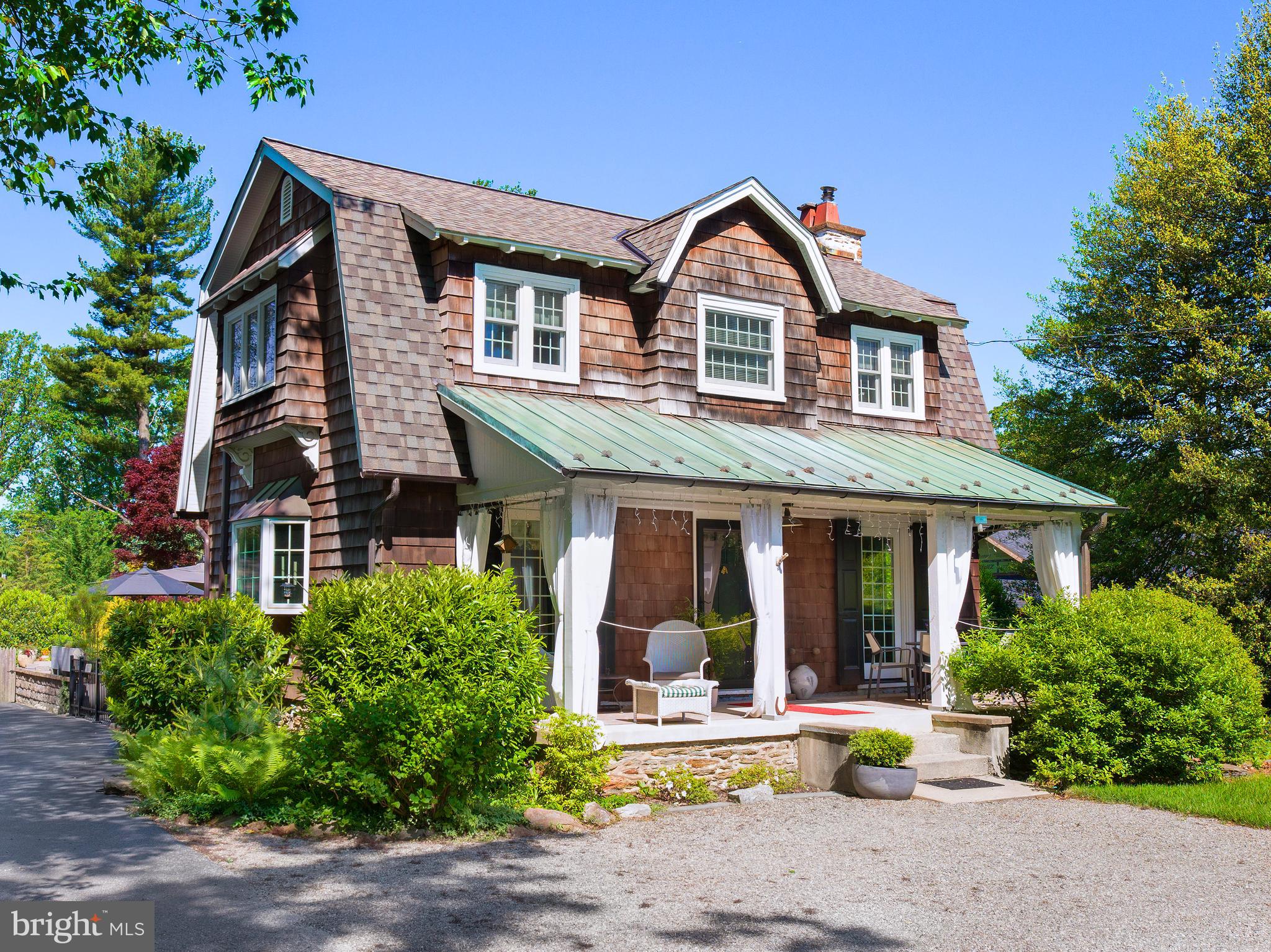 Welcome to this enchanting Dutch Colonial Revival home, gracefully nestled in the heart of the award-winning Tredyffrin-Easttown School District. Featuring 3 spacious bedrooms and 2.5 baths, this residence is a perfect blend of timeless elegance and thoughtful modern updates. Classic cedar shake siding, mature evergreens, and a series of low-maintenance gardens create a storybook setting with year-round visual interest and a sense of natural privacy. From the moment you arrive, the home’s inviting curb appeal and carefully designed landscaping evoke a sense of peace and warmth. Step onto the welcoming front porch, complete with weatherproof drapery—ideal for entertaining or simply enjoying a quiet, rainy evening. Enter into the sunny foyer with hardwood floors. A cozy family room with gas fireplace is situated on your left. Continuing to the right is a charming dining room which flows into the beautiful kitchen. The kitchen and adjoining breakfast room/ family room were part of the two story addition completed by the owners in 2001. This area of the home also includes a powder room and efficient mudroom with access to a side patio-convenient for everyday use. A lovely window seat at the far end of this area, flanked by closets for extra storage, overlooks the spacious backyard with lovely gardens. Upstairs you will find a spacious primary bedroom with walk-in closet and a charming en-suite full bath. Two additional bedrooms (one currently used as a second floor laundry room and workout area) on this level have access to the large hall bath (enlarged 2005, refreshed in 2020) . In warmer months, the backyard patio transforms into a delightful second living room, perfect for hosting or relaxing under the trees. Inside, every room has been cherished and enjoyed, filled with love, laughter, and abundant sunlight. Extensive system upgrades that ensure comfort and efficiency—updated electric (2001), conversion to gas and new furnace (2014), new hot water heater (2014), and high-efficiency mini-splits (2014). The original cedar siding was replaced (2010), and premium copper gutters, flashing, and venting systems have been installed for long-term durability and classic appeal. Additional improvements include: New patio (2008, refreshed in 2022), front porch deck replacement (2016), gas fireplace conversion (2018). Exceptionally located, the property offers unparalleled convenience with quick access to commuter rail, major highways, top-rated schools, and a wide variety of shopping and dining destinations. 442 Old Eagle School Road is more than a home—it’s a lovingly cared-for sanctuary where charm, character, and convenience come together in perfect harmony.