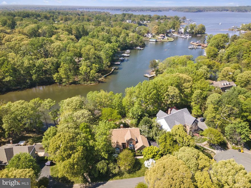 Welcome to the stunningly renovated 1102 Spy Glass in the coveted Ulmstead Cove community! This picturesque locale, just a stone's throw from downtown Annapolis, offers a plethora of desirable amenities including a private community beach, sport courts and serene walking trails.

This home is truly a rare gem, as it's one of only six waterfront homes on the street, complete with a private, deep-water dock that grants convenient boat access to several waterfront restaurants, numerous marinas and the majestic Chesapeake Bay.

The first floor of this luxurious abode boasts a welcoming kitchen with a granite countertop island, top-of-the-line stainless steel appliances and ample cabinet space. Connected to one side of the kitchen is a bright and airy breakfast room, with skylights that usher in natural light and provide access to an expansive deck perfect for entertaining or simply relaxing amidst lush gardens.

The first floor also features a family room with soaring cathedral ceilings and a sumptuous owner’s suite complete with an en-suite bathroom boasting a spacious vanity area, a jetted tub and a separate walk-in shower. The pièce de résistance of the owner’s suite are the sweeping windows that showcase breathtaking views of the water and verdant gardens.

On the second floor, you'll find two bedrooms connected by a Jack and Jill bathroom as well as a third bedroom that could easily be used as a second owner’s suite, complete with a full bath and a walk-in closet.

If you're seeking even more living space, retreat to the lower level where over 1600 square feet of living space awaits. The lower level boasts a cozy family room with an inviting fireplace, a spacious bedroom, a large full bathroom, a den with a cedar closet and even a utility room that's perfect for storing kayaks, paddle boards and other water toys.

As an added bonus, all windows, the roof and skylights were replaced in 2020, and the kitchen, bathrooms and flooring were redone in 2022. The whole house was also painted in 2023. Other features include a whole house generator, irrigation system, radon mitigation system, and dual zones HVAC systems. With a large dock and boat lift boasting an estimated 4 feet of MLW, this property truly has it all. See seller disclosures for bylaws and additional information about the home, and don't hesitate to reach out for a private tour. This is waterfront living at its finest!