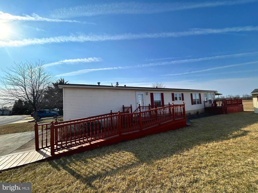 Welcome to easy living in this well-maintained double-wide manufactured home, nestled in a sought-after 55+ community that offers a serene and welcoming environment. The open floor plan features a spacious living room with  cathedral ceilings, creating a bright and airy atmosphere. The roomy kitchen includes all appliances, even an upright freezer, and a convenient breakfast area just off the kitchen — perfect for casual dining.  

Enjoy the ease of a dedicated laundry room with a washer and dryer, along with a versatile family room complete with a closet. The cozy sunroom, featuring a gas fireplace, provides a warm retreat for relaxation year-round.  

This home backs up to peaceful open land, offering a tranquil backdrop for your everyday living. Step outside to find side and rear decks providing additional outdoor living space, ideal for enjoying the fresh air and beautiful views.  A shed with electric makes the perfect workshop for your hobbies or storage needs. 

This home offers natural gas heat, central air, 200 amp electric shingled roof and ramp access to the home for added convenience, comfort is yours in every season.  

The well-kept community offers wonderful amenities including a clubhouse, activities, and more. This is truly easy, enjoyable living at its finest! Pets are welcome here. Buyer must be approved by Shadowstone Village.