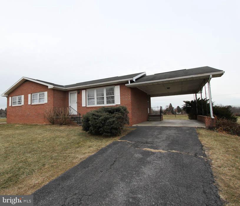 Cozy 3 bedroom, 1.5 bath brick rancher with covered carport & long private driveway. Home is situated on a large lot. Kitchen/dining combo. Nicely sized bedrooms. Hardwood floors throughout living room and bedrooms. Large unfinished basement perfect for your storage needs. Basement includes built in workman benches. Large backyard. Washer and dryer included. Rent includes a Utility & Maintenance Reduction Program. Pets ok on a case by case basis. EHO