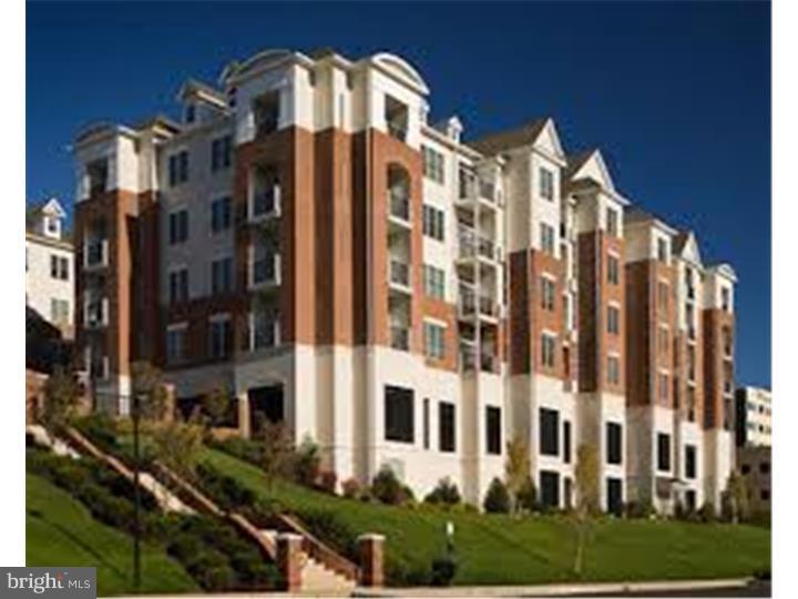 Spectacular 2 bedroom/ 2 bathroom condo at the Grande...maintenance free living at it's best! On site fitness center, in-ground pool, bbq areas & laundry located in unit are just a few of the amenities offered. This unit is the complete package...was once the model unit for the entire complex! Conveniently located on the ground level, very close to the side entrance and elevators. Enter condo directly into hallway that leads to the open-concept living area. Laundry space with full washer and dryer located in the main hallway. Gourmet kitchen features stainless steel appliances, beautiful tile back-splash, corian counter tops, 42" cabinets & breakfast bar overlooking the living space. Living space includes recessed lighting, crown molding, 9' ceilings & built-in desk space...great for a home office! This layout also includes two separate patios with storage sheds overlooking the well manicured courtyard...great for warm weather entertaining! Main bedroom features two closets, one is spacious walk-in & full bath with standing shower and soaking tub! Second bedroom & full bath located opposite of master, also includes a large closet. This community is conveniently located within walking distance to area shops, restaurants, nightlife & public transportation! Easy access to all major highways & just a quick commute to the city!