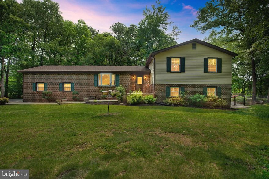 Wonderful 4 BR/3 BA split-level home in the sought out neighborhood of Country Lakes with NO HOA (grandfathered in)  situated on a 1.49 acre level lot and surrounded by mature trees!   This home boasts gorgeous wood floors throughout which really give this home a cozy feel.  The kitchen has been fully  updated  with new cabinetry, granite countertops, island and  GE stainless steel appliances (2013).   There is an open and airy feel throughout the home with large rooms to include the primary BR with its own private bath and walk in closet.  The wood burning stove will keep you warm at night in the huge basement den area where the wood flooring extends and it fully walks out to the side yard of the home.   Plenty of sunlight pours into the den in the lower level of the home which also includes  the  fourth bedroom and additional full bath.  Down the hallway off the den, there is a  separate laundry/utility room that walks out to the rear of the house for easy access from the rear yard and stunning POOL!    YES , this home has a gorgeous Gunite concrete pool installed by Stevenson's Pool Company in 2001 and has been professionally maintained so you will have no worries.  McConnell Pool will be happy to certify and discuss all maintenance completed over the years!   Depth range is 3, 6, and 9 at diving board.  The pool is fully fenced in with child protection locks and has a large patio area surrounding it with additional sun deck.  The oversized garage is a great  for the handyman and/or mechanic of the family and also includes an awesome Lifestyle Garage Screen making this area a wonderful place for indoor/outdoor expansive entertaining. Perfect for CRAB FEASTS !    The  Sellers have done numerous updates to this  home over the last 10 plus years to include: Roof  and updated screen-in porch and deck (2019);  HVAC has been serviced seasonally and new outside air handler installed in 2021;  Upgraded 4 ft. concrete walk ways leading to the expanded front patio and to the back yard and pool area;  and the driveway is "overwide" at  12 ft.  for plenty of off road parking.  There are upgraded Simonton Windows installed in 2010 and wood doors throughout.     Sellers have meticulously  maintained this home and it will NOT disappoint!  Sellers need to find HOC  45-60 closing window (July).   Sellers requesting settlement with Interstate Title and potential buyers to be fully pre-approved (doc verified) with a local lender.