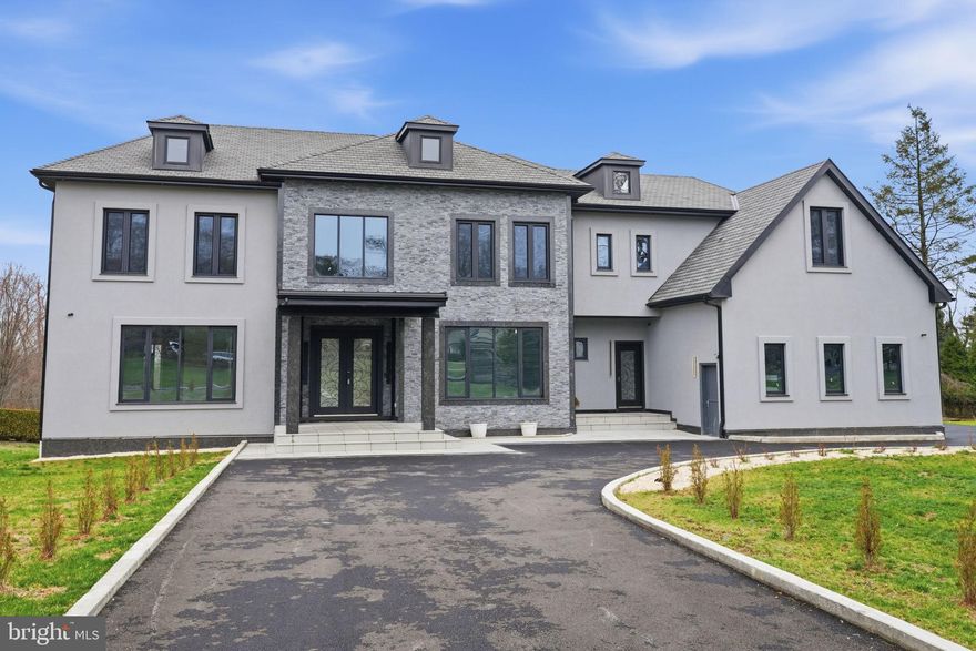 Set on over 1.4 acres in the heart of prestigious Lower Moreland Township, 1047 Welsh Road redefines modern luxury living. This brand-new construction presents an exceptional blend of striking architectural design, refined finishes, and timeless craftsmanship, all within one of the area’s most desirable locations.

Future homeowners will enjoy the rare opportunity to personalize the property’s lower level, pool, and landscaping, creating a truly custom retreat that reflects their individual style and vision.

From the moment you arrive, the home’s dramatic exterior makes a statement with its bold dark tones and meticulous detailing. Step through the grand entryway into a sun-drenched interior that welcomes you with rich hardwood flooring, soaring ceilings, and a stunning central staircase that anchors the open floor plan.

The spacious living room features two floor-to-ceiling marble fireplaces and walls of glass that flood the space with natural light, offering the perfect balance of warmth and sophistication. The formal dining room flows effortlessly into a chef’s dream kitchen, complete with dual oversized islands, custom cabinetry, quartz countertops, and top-tier stainless steel appliances that combine style with function.

A private study, two full bathrooms, and access to a three-car garage complete the main level.

Upstairs, four beautifully proportioned bedrooms each enjoy their own private ensuite. The primary suite is a sanctuary of comfort and style, showcasing dual walk-in closets and a spa-like bathroom featuring a freestanding soaking tub, glass-enclosed shower, and elegant designer finishes throughout.

The lower level, complete with drywall, electric, and flooring, awaits your finishing touches. Whether envisioned as a media room, gym, guest suite, or entertainment space, it offers endless flexibility with a separate private entrance.

Step outside and experience a backyard oasis that rivals a private resort. A sleek glass pergola overlooks a stunning custom pool and expansive patio surrounded by professionally designed landscaping—perfect for gatherings or quiet evenings under the stars.

Created through the collaboration of a renowned architect and skilled builder, this residence embodies exceptional quality, thoughtful design, and elevated style.

Don’t miss the chance to make this extraordinary new construction your own. Contact the listing agent for details on customization options and design selections still available.