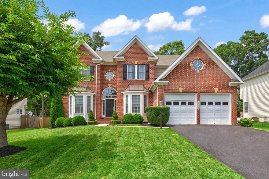 Discover this stunning home in the highly sought-after White Oak Estates, zoned for Colgan High School! Built by the esteemed Hylton Homes, the Carlyle model,  this exquisite residence offers four spacious bedrooms and three and a half luxurious bathrooms, with three newly updated. Upon entry, you'll be greeted by a grand entrance leading to the formal dining room on your right, and to the left, a living room, office, and half bath. A stunning two-story fireplace graces the family room, seamlessly flowing into the open-concept kitchen. The kitchen is a chef's delight, featuring a lovely island and a breakfast room that opens onto a patio, creating the perfect combination for entertaining!
Dual staircases, with elegant wood steps and carpeted centers, add to the home's charm and functionality. The formal dining room also provides an ideal space for entertaining. The upstairs offers four generously sized bedrooms and two bathrooms, providing ample space and comfort for family and guests alike. Each bedroom is designed with space and functionality in mind, ensuring everyone has their own retreat. The charming primary suite is a true highlight, boasting a sophisticated tray ceiling that adds an element of elegance. The luxurious bathroom is a spa-like haven, featuring dual vanities for convenience, a separate tub for soaking, and a shower for a refreshing experience. Additionally, the suite includes spacious primary closets, offering plenty of storage for all your wardrobe needs. This suite is designed to be a peaceful and luxurious escape within your home. The finished basement is a standout feature, complete with a bar area, a versatile room that can be considered a bedroom, another flex room, and a full bath. This lower level adds even more living and entertainment space, making this home a true gem.