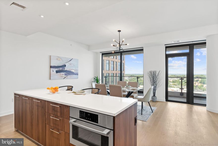 Welcome to an exquisite new condo nestled within the captivating Verse at Tysons Corner! This sun-drenched and spacious two-bedroom residence boasts two full baths and a separate office, providing the ultimate in comfort and convenience. With the added appeal of two assigned garage parking spaces and a trio of storage units, your every need is thoughtfully met.

Indulge in the artful elegance of the Cecconi Simone designed kitchen, featuring stunning Italian cabinetry, composite stone counters, and a full-height backsplash, all complemented by top-tier appliances. Immerse yourself in the luxury of hardwood floors that grace every corner, while the awe-inspiring 10-foot floor-to-ceiling windows frame panoramic views of the majestic Blue Ridge Mountains.

The opulent community is a haven of extravagance, offering an inviting lobby with a 24-hour concierge, an exceptional fitness center complete with a serene yoga studio, and an entertainment lounge for social gatherings. Step outside to the extraordinary Sky Park, an outdoor oasis perfect for gatherings and grilling, and enjoy the convenience of bicycle storage. Pamper your guests with the sophistication of hotel-like services in the guest suites, and savor moments of leisure by the inviting outdoor pool.

Nestled in an exceptional location, you're mere steps away from the Greensboro Metro, Whole Foods, the Show Place ICON Theatre, and an array of enticing restaurants and boutiques. Experience a lifestyle beyond compare, where every detail is carefully curated to exceed your expectations. Welcome home to an unparalleled living experience at Verse in McLean, Virginia.