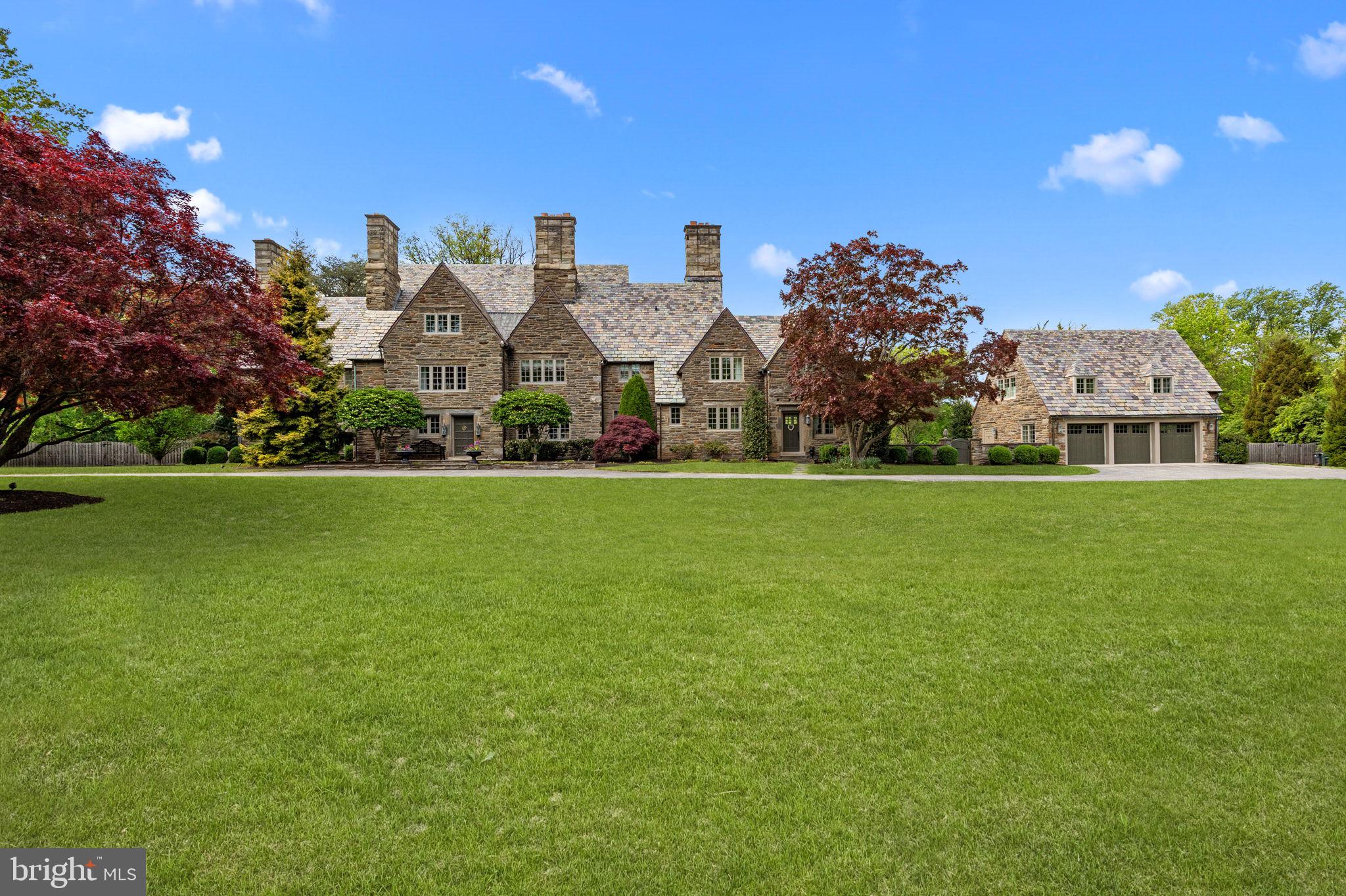 Step into luxury with this majestic stone Colonial where timeless elegance meets modern comfort! This home is located on one of the most exclusive streets in Abington Township. Spanning an impressive 7,485 square feet, this home is a true sanctuary nestled on 2.41 acres of pristine landscape with a newly renovated in-ground pool. Enjoy the beauty of nature right outside your door. This remarkable property seamlessly blends classic architecture with modern updates, making this home provide the perfect setting for lavish soirees or quiet evenings. A circular driveway leads you to the front of the home. Enter the expansive Foyer with a front and back entrance and inlaid mahogany floors. The spacious Living Room and formal Dining Room have two wood burning fireplaces, these are 2 of the 8 fireplaces in the home. The hardwood floors and deep window sills throughout the home create the ambiance of formal living from the 1900s. The Family Room has a flagstone floor and french doors that open to the backyard, where you can appreciate the large slate patio overlooking the picturesque backyard. Back inside, the Library creates a perfect cozy space to unwind and read your favorite book with a wood burning fireplace and wood paneled walls. This room also has built-in shelves and cabinets. To continue the entertaining, there is a Tavern Room that opens to a Breakfast Room that has a fireplace and doors opening to the flagstone patio. Step into the elegant chef’s Kitchen that will make you culinary dreams come true. The Kitchen features a Wolfe range with 6 gas burners, two sets of built-in Paykel dishwashers, sub-zero refrigerator, two sinks, white cabinets, some with glass fronts surrounded by Calacatta Gold marble countertops. For informal eating, enjoy a cup of coffee at the large center island with seating. The eating area has door access that opens to the beautiful courtyard area that leads to the three Car Detached Garage with its own HVAC system. The Garage features a second floor with two more Bedrooms and a Full Bath. Take the Grand staircase in the Foyer or back staircase to the second level. The Primary Bedroom Suite has a wood burning fireplace and a small balcony that allows sunlight and fresh air in. There is also a Dressing Room with built-in closets and drawers. This room connects to the updated Primary Bathroom with a large stall steam shower, double sinks with a marble countertop, water closet, a free-standing tub and radiant floor. In addition, there are three more Bedrooms with great closet space. Two Bedrooms share a Jack and Jill Bath with a stall shower. Another Bedroom has a wood burning fireplace and its own Full Bath with a stall shower. Completing this floor is another area with Heart of Pine wood floors, a Bedroom, a Hall Bath, a convenient Laundry Room that could be another Bedroom, steps to third level with a large attic and a spacious unfinished Basement. The house features a slate roof, 4 zone HVAC, all new custom windows and updated electrical system. Don’t miss the opportunity to own a piece of history, it doesn’t come along often. Experience the perfect blend of tradition and modern living. Call today to make your dream home a reality!