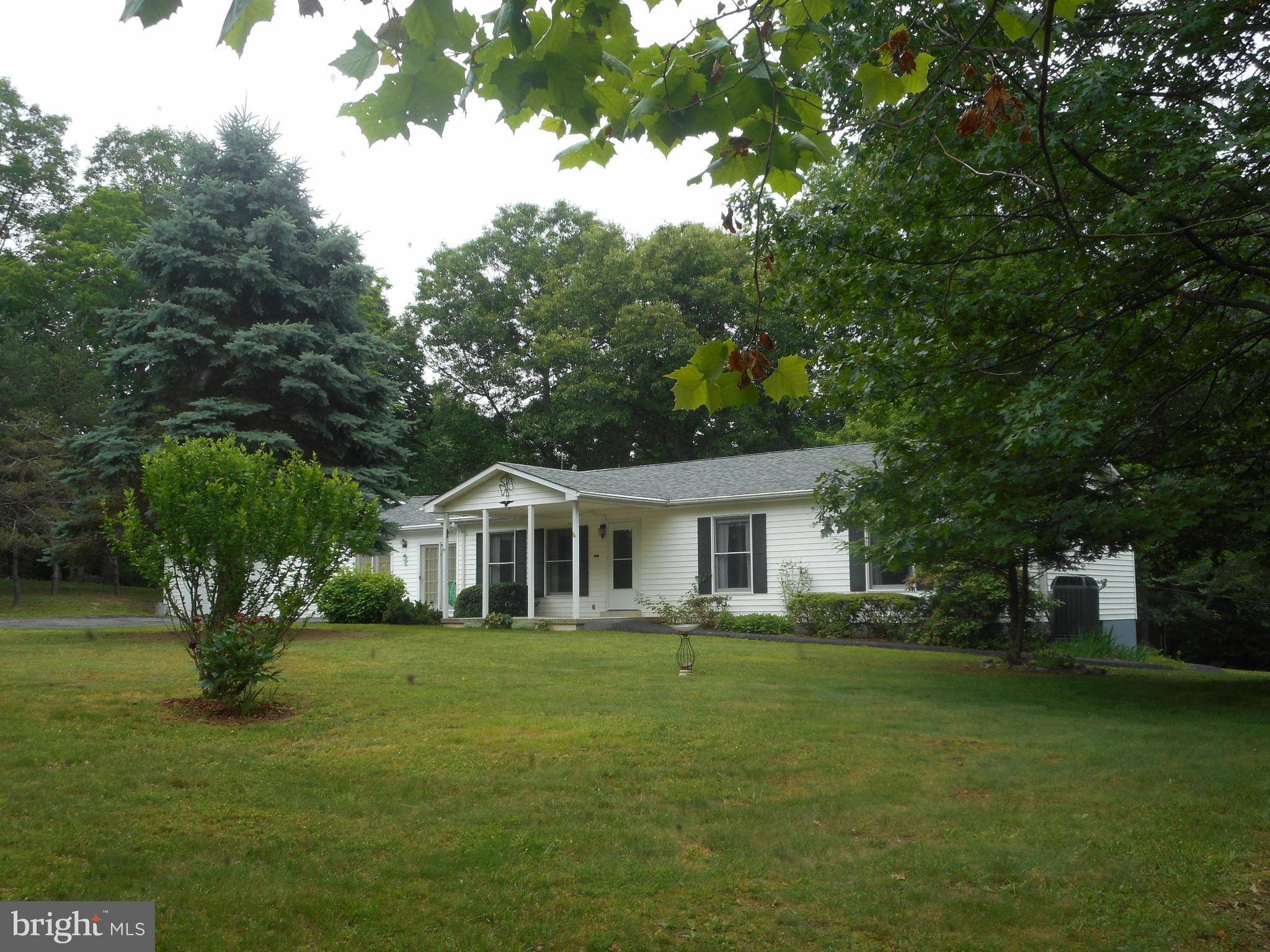 Home is in immaculate shape, partially wooded and some clear. Lot is level around home. Large deck, blacktop driveway. Close to town and all the conveniences! Move in condition!! Nice community and semi private. Only about 3 miles from town, restaurants and the new hospital. Shows beautifully, has a warm and welcoming atmosphere. Seller will concider reasonable offers! Wheel Chair accessible.