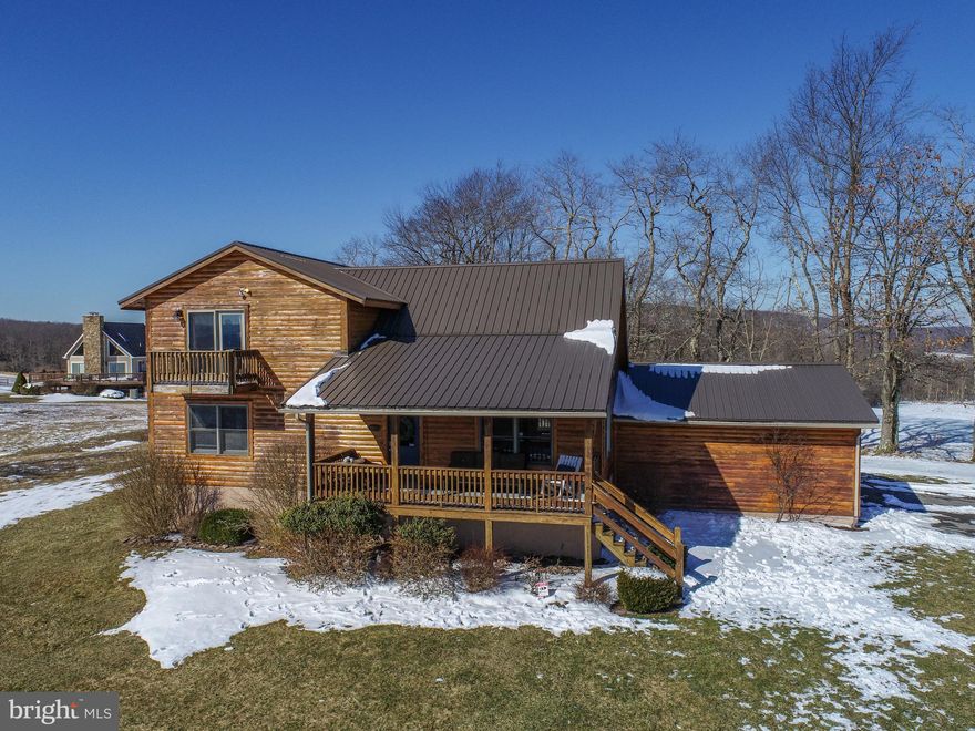 Mountain Top Lake Access Log Home at Deep Creek Lake – This 5 Bedroom, 3 Bath lodge is situated on .85 acres of mountain top land and features a 2 car garage, modern kitchen & bathrooms, metal roof, hardwoods with timber accents and picturesque views of Deep Creek Lake! Located in “Paradise Ridge”, you’ll enjoy one of the nicest Lake Access areas at Deep Creek, with plenty of parking, a pavilion, picnic area and sandy beach perfect for swimming, fishing or kayaking. Massive primary suite on the upper level, with adjoining loft overlooking the great room. Plenty of additional living space on the back deck, covered front porch and fully finished basement. Sold “Turn Key” fully furnished. If you’re looking for a ridge top Log Home overlooking Deep Creek Lake, just minutes from local establishments, state parks and Wisp Resort – you don’t want to miss this one… Call today for details!