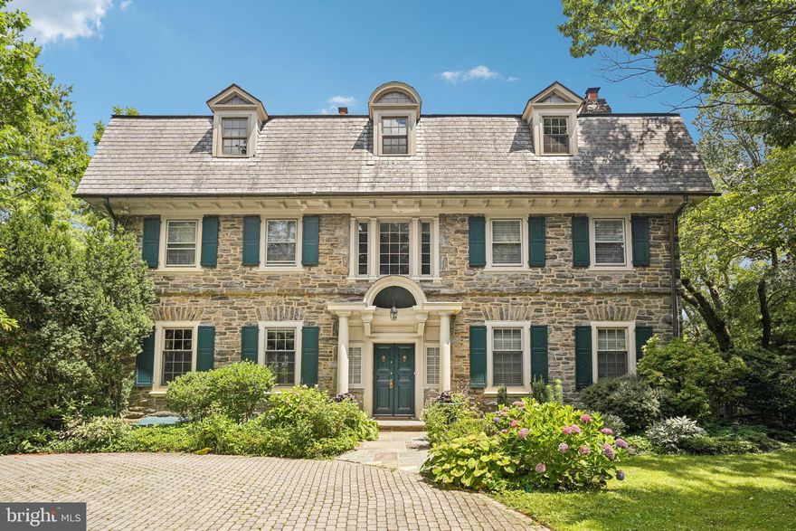 Welcome to 1107 Montgomery Avenue - a historic Main Line estate that was once the childhood home of Second Lady Margaret “Happy” Fitler aka the wife of Vice President Rockefeller. This 6 bedroom, 5.1 bathroom home in top rated Lower Merion Schools boasts a 10ft+ ceiling height; locally mined Wissahikon stone exterior; hardwood floors throughout all 3 levels; a formal yet welcoming floor plan; three fireplaces; and is situated on a 0.9+ acre, flat lot. Walking through the two-story foyer, you are greeted by a large living room with a gas fireplace and a formal dining room with beamed ceiling and built-in, corner china cabinets. Follow through, to the newly remodeled kitchen with island seating, quartzite counters, GE Monogram and Bosch appliances that include a French Oven, built-in microwave, and wine cooler. The airy sunroom overlooks the flat, rear yard and flagstone patio - perfect for outdoor dining. The second floor offers a luxurious primary suite with a huge walk-in closet with built-in system; gas fireplace; and a newly remodeled bathroom with radiant heat flooring, soaking tub, spa-inspired shower and dual vanity; a second en-suite bedroom with private bathroom; and laundry room. The third level offers a third ensuite bedroom with private bathroom, 3 additional spacious bedrooms and a shared bathroom. The lower level is partially finished offering flex space for a gym or storage and a full bathroom with stall shower. Since ownership, the sellers have done a great deal of work some of which includes 2 new HVACS, a new 80 gallon hot water tank, refinished hardwood flooring, renovation of 2 guest bathrooms, and the addition of landscape and exterior lighting around the exterior. All of this plus being in an amazing location - walkable to Rosemont train station, Ashbridge memorial park and playground, Lancaster Ave shops and dining, the Shipley School and Bryn Mawr College and minutes to downtown Wayne and Suburban Square and all major roadways for an easy commute. Call today for more information regarding this one-of-a-kind property- it is not to be missed!