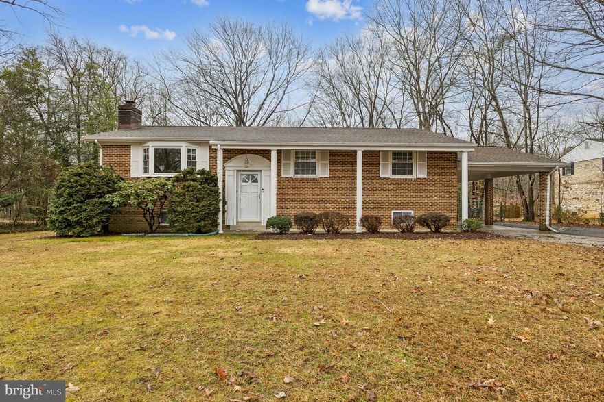 Elegant all brick GORGEOUS split foyer on a serene nearly half-acre lot!  With a fantastic commuting location, this well-maintained home features 3 bedrooms upstairs with a huge potential 4 bedroom/office in the basement, 2.5 bathrooms, and two spacious family rooms (one on each level). The wonderful warm lower-level family room showcases a newly lovely, white-washed brick wood-burning fireplace insert. The home features fresh paint and gorgeous brand-new flooring and carpet throughout. The updated kitchen was updated approximately 11 years ago and flows nicely into the separate dining room, perfect for family gatherings. Step outside to the enormous deck overlooking a fenced, lush, park-like backyard, ideal for entertaining or simply relaxing in your private outdoor retreat. Major updates include a newer HVAC system (approx. 6 years), roof (approx. 5 years), and a beautifully updated primary bathroom (5–6 years). A wonderful blend of comfort, charm, and outdoor space ready for you to call HOME!