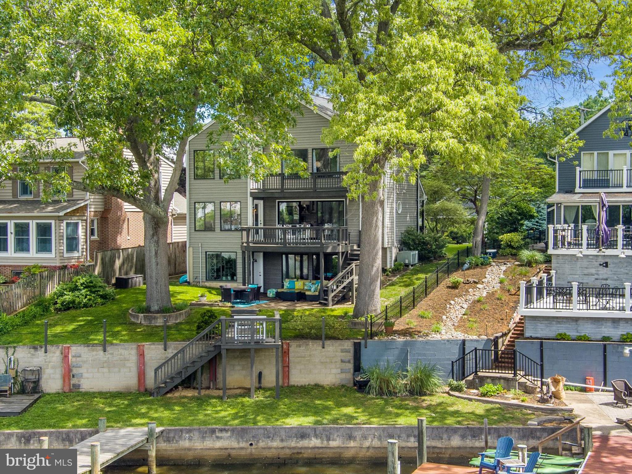 Waterfront Playground – Your Ultimate Entertainer's Paradise!
Get ready to live your best waterfront life at this stunning COMPLETELY REMODELED TOP TO BOTTOM three-level escape! With over 5 feet of deep water, a boat lift and jet ski lift. This place is basically summer camp for grown-ups—except you actually own the cottage.
Step inside to an open-concept main level that practically begs for dinner parties and game nights. The gourmet kitchen is loaded with a center island big enough for dancing, gas cooktop and beverage fridge—because why walk to the bar when it’s right here?
The magic happens when you step out onto the waterside decks and brick patio. Friends laughing, drinks flowing, fresh crabs steaming, and the sun setting over your private dock. Yeah, it’s as good as it sounds.
Upstairs, the primary suite is your personal retreat with a walk-in closet and a spa-inspired bath—soaking tub, glass shower, and a cozy seating area perfect for winding down.
The lower level is your relaxation and celebration hub. Bright and inviting with walk-out access to the patio and dock, it’s perfect for movie marathons or crab feasts by the water. The detached garage is ready to store all your water toys, gear and maybe a car or two.
And did we mention? You’re just doors down from The Point Crab House—so when grilling isn’t on the menu, head over for dinner and a cool crush!
Bring your sense of adventure—and your friends. This one won’t last