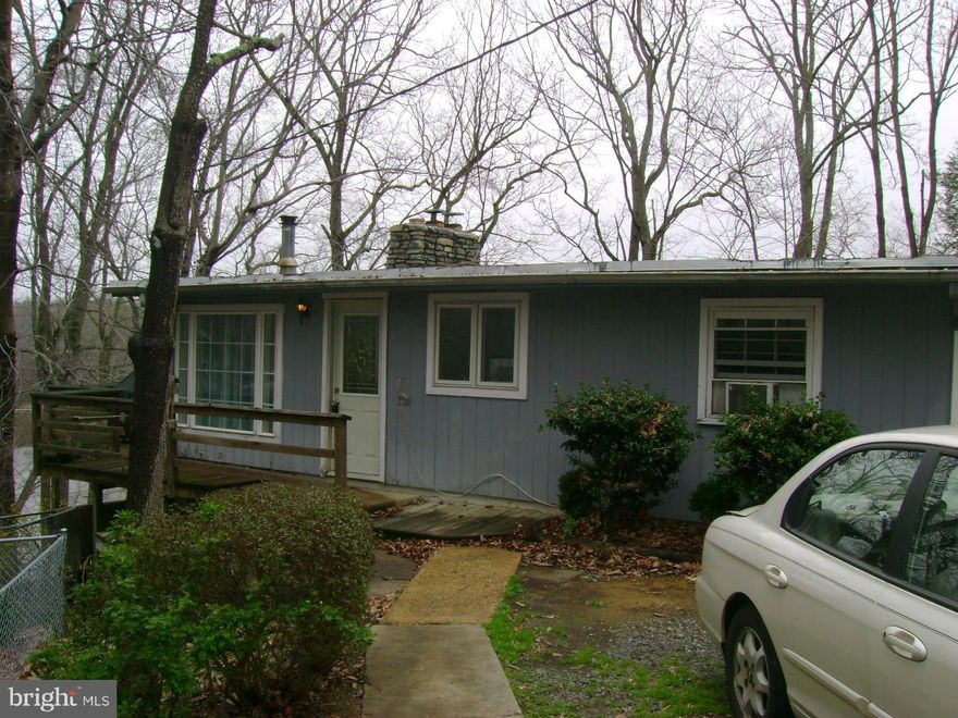 WOODS AND LAKE VIEW, NATURALLY ENHANCED ENVIRONMENT OFF THE BEATEN PATH , 2 BEDROOMS, 2 FULL BATHS, FIREPLACE AND RUSTIC CHARM , OPEN FLOOR PLAN, LOWER LEVEL HAS LARGE ROOM WITH FIREPLACE AND FULL BATH COULD BE 3RD BEDROOM,   SOLD AS IS AND IS SUBJECT TO 3RD PARTY APPROVAL, SELLER WOULD LIKE TO USE CARDINAL TITLE, HOME WARRANTY WILL BE PROVIDED WITH CARDINAL TITLE.  OPEN HOUSE 4/19  1-4