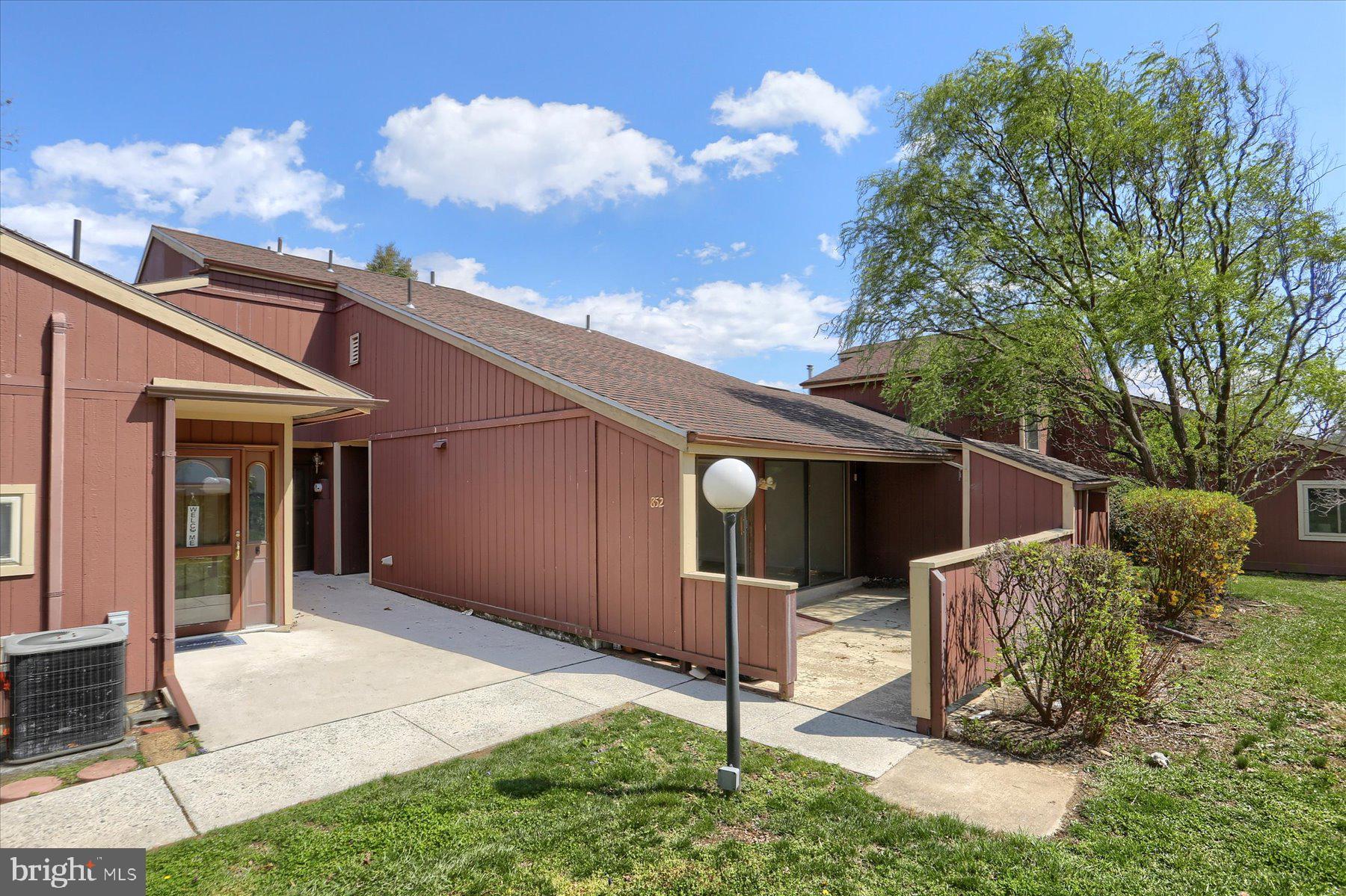 Remodeled and ready for a new owner. This home has a ramp off the patio and at the assigned parking spot. All new luxury vinyl plank just installed in kitchen, dining, living room, hallways, closets, owners bath and both bedrooms along with new trim and baseboard (2025). New kitchen faucet with sprayer (2022) All new lighting in hallways, kitchen, dining, living room, bedrooms and owner's bath. Owner's bath has a large, low threshold shower with handrail, handrail beside chair height commode (replaced 2022), new vanity and faucet (2025). Hall bath updated with new vanity and lighting (prior to 2022) with new chair height commode (replaced 2022). New lever handles for ease of use (2025). All new light switches, outlets, and cover plates. Freshly painted throughout (2025). New heat pump installed August 2022 with regular service. This home has an extra large patio off the living room and dining room sliding patio doors with a storage area. This home is ready for you to move right in. Do not delay. Come tour today. Professional photos and floor plan have been added. Some photos have virtual staging and are marked as such. Seller is a PA licensed Realtor.
