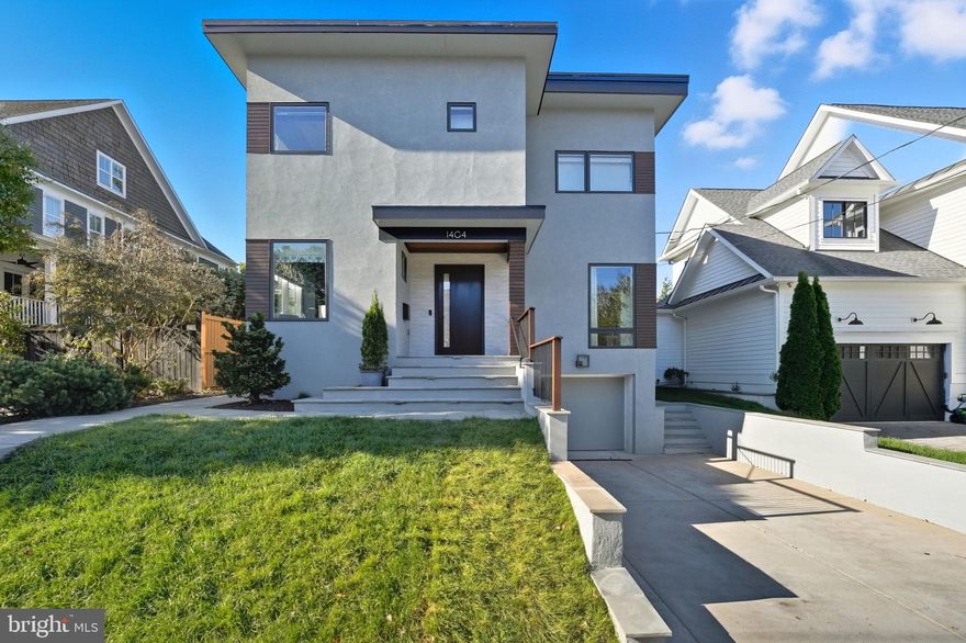 Stunning modern masterpiece designed and renovated in 2016 by acclaimed Moser Architects, seamlessly blends cutting-edge design with refined comfort. Nestled in the highly sought-after Lyon Village, it showcases a light-filled, open layout that exudes both sophistication and warmth.  Every detail reflects the vision of the current owner, a talented interior designer, who curated and professionally finished the interiors with an elevated sense of style. >>> Upon entry, soaring ceilings, white oak flooring, and Italian lighting by Artemide set the tone for the home’s contemporary elegance. The striking dining room features Schumacher wallpaper, custom cabinetry, and Scandinavian lighting by Louis Poulsen. A gorgeous, dedicated home office with custom built-ins complements the design. Along the inner hall, a custom mural by NYC’s Calico Wallpaper leads to the mudroom and powder room with Kelly Wearstler for Visual Comfort lighting and finished with Scalamandre wallcoverings. >>> The open-concept living area, wrapped in walls of windows, is centered around a state-of-the-art kitchen by Jack Rosen Custom Kitchens, featuring Canadian Elmwood cabinetry and Dekton countertops, a walk-in pantry, butler’s pantry with beverage center, and a custom banquette upholstered in Christopher Farr Cloth. >>> Upstairs, the primary suite includes two custom-designed walk-in closets and a luxurious spa-inspired bath with an oversized shower and bench seating. Three additional bedrooms, two full baths—one showcasing a Scandinavian light fixture by &Tradition—and a convenient laundry room complete the upper level. >>> The lower-level recreation room with 10-foot ceilings offers an ideal space for relaxation and exercise. A guest bedroom with full bath and second laundry room complete this level, with direct access to the attached garage. >>> Outside, professional landscaping, flagstone walkways, and a private patio provide a serene backdrop for outdoor entertaining or play.>>> This unmatched Lyon Village Location offers the perfect balance of tranquil residential living with urban convenience. Walk to two neighborhood parks, the library, and the local dog park, while enjoying effortless access to Clarendon's vibrant dining, shopping, and Metro (just two blocks away). The quiet street setting provides peaceful residential charm while quick access to I-66 ensures seamless commuting throughout the metropolitan area. The home is a short, easy walk to Arlington Science Focus Elementary School. Community Spirit Without Restrictions: Lyon Village features no formal HOA, offering homeowners freedom and flexibility, while the active neighborhood association fosters genuine community connection through beloved annual events including the festive 4th of July parade and popular spaghetti dinner fundraisers—creating opportunities for neighbors to connect and build lasting memories. This is more than a home—it's a lifestyle opportunity in one of Arlington's most desirable neighborhoods, offering the perfect fusion of contemporary design, thoughtful renovation, and premium location.