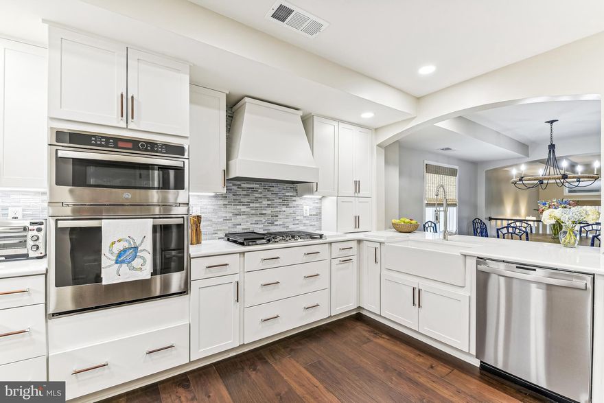 Welcome to this DESIGNER SHOWCASE  including a custom painted entry that draws you in the moment you open the door.   Owner worked  with a reputable interior designer to select all finishes  to include designer light fixtures, gorgeous real hardwood floors, custom designed bathrooms, and so many interesting trim details.  Transitional timeless design with a coast twist.  ONE OF A KIND and RARE GEM! END UNIT.   Not one detail has been overlooked!  And a beautiful gated waterfront and water-privileged community.  BE PREPARED to be wowed when you open the front door with a top of the line renovation over $350,000.  NOTICE ALL OF THE BEAUTIFUL ARCHED DOORWAYS!New Bosch HVAC, and tankless hot water heater.  All the vents were professionally cleaned after renovation.  This is an opportunity that doesn't come along too often  to move right into a turn-key TOTALLY  RENOVATED  & AND REDESIGNED BY AMAZING LOCAL DESIGNER !! gorgeously designed home in the exclusive community of Chesapeake Harbour. No expense has been spared to make this custom first-class from floor to ceiling.  Totally redesigned  and totally renovated with all permits.  Custom window treatments throughout and designer light fixtures.  Custom gourmet kitchen with quartz counters, stainless steel appliances, an abundance of drawer storage, perfect bar/pass through  and much more!  Three bedrooms and three full bathrooms.  Each space offers light and invites you to relax and be happy you don't have to redo anything.  Two-car garage with storage room and storage installed in ceiling of garage.  Two gas fireplaces.  Beautiful custom shiplap in living room and master bedroom. Multiple decks and from the top deck off master, owner loves to  relax and watch the boats and bay bridge.  His and her custom closets. And talk about the community, Community beach and pier and two pools, one heated and one waterfront looking out at the Bay.  Tennis and pickleball courts for your fun and exercise.  Don't worry about getting your steps in with all the  waterfront walking paths, If you don't feel like cooking, walk on over to The Beacon with dockside seating .  This is a gated community with 24/7 security and guard gate.  You can have it all with the best of coastal living in this vibrant and secure community. The pictures really don't do it justice.  WAS TEMP OFF THE MARKET NOVEMBER TO NOW!