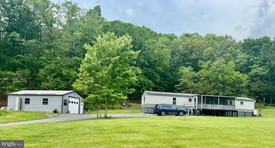 Escape to your own private retreat with this charming 3 bedroom, 1.5 bath home nestled on 4 peaceful acres. Surrounded by nature, this secluded property offers the perfect blend of comfort, space, and self-sufficiency.

Inside, you'll find a warm and inviting layout with plenty of natural light. Enjoy the outdoors year-round from the spacious screened-in porch perfect for morning coffee or evening relaxation.

The home includes a two car garage plus an additional one car garage, providing ample space for vehicles, tools, or a workshop. The land is rich with mature fruit trees and thriving grape vines, offering the joy of homegrown harvests and endless possibilities for gardening or expanding.

Whether you're seeking a quiet full-time residence or a peaceful weekend getaway, this unique property delivers privacy, beauty, and room to grow!