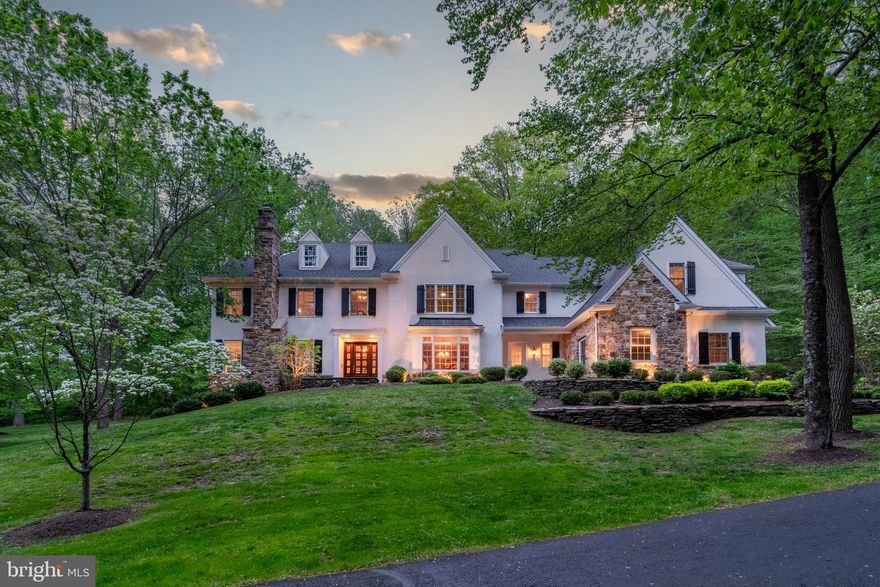 Perched gracefully on Jericho Mountain in Upper Makefield, this exceptional custom-built home by Zaveta Homes is a masterclass in refined living, timeless design, and thoughtful craftsmanship. Set on a gently elevated 5+acre parcel at the top of a scenic enclave, it offers rare privacy and serenity just minutes from the vibrant towns of New Hope and Newtown. A circular driveway leads to a stately home framed by mature hardwoods, a Koi pond, and newly manicured grounds. Both a three-car attached garage with hook-up for an electric vehicle, and a two-car detached garage with a room above provide ample space for car enthusiasts. Inside, the home opens to a gracious foyer with gleaming hardwood floors, curved archways and extensive crown molding. Formal living room with a wood burning fireplace and dining rooms offer elegant settings for entertaining, while the family room, with its 12-foot ceilings, full masonry fireplace, and walls of windows, serves as a welcoming gathering space with scenic views in every direction. The gourmet kitchen is a chef’s dream, outfitted with a 48" Sub-Zero refrigerator, double wall ovens, six-burner Wolf cooktop, subway tile backsplash, elegant covered vented hood, black soapstone countertops, farmhouse sink, a walk-in pantry, and a cherry-topped center island with seating .  Completing the kitchen area is a convenient built-in desk with views of the rear wooded landscape and a butlers pantry with an extra refrigerator and additional cabinetry.  It connects seamlessly to a spacious breakfast area and the family room, with access to a large flagstone patio overlooking the peaceful waterfall and pond, making this home ideal for both everyday living and special occasions.  A handsome study with French doors opens to a screened-in porch, while the mudroom, with built-in cubbies and a secondary entry, keeps everyone organized. Two powder rooms and a rear staircase complete the well-designed main level. Upstairs, the gorgeous primary suite features a tray ceiling, sitting room, dual walk-in closets, and a luxurious bath with whirlpool tub, oversized shower, and double vanities. Four additional bedrooms, including a princess suite, Jack and Jill bedrooms, and a guest suite, as well as a laundry room and a walk-up attic with generous storage, round out the second floor. The lower level offers additional lifestyle enhancements, including a newly finished bedroom with en suite bath and French Doors providing walk-out access, a home gym, a theater room and substantial storage space, further evidence that this home is as functional as it is beautiful.  Expertly built, impeccably maintained, and perfectly positioned in one of Bucks County’s most scenic settings, this Zaveta home offers a rare combination of luxury, privacy, and natural beauty. Don’t miss it!