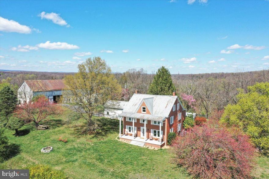 SELLER OFFERING 2% towards RATE BUYDOWN AND/OR BUYERS CLOSING COSTS.  SEE ATTACHED DOCUMENTS FOR INFORMATION ON 2/1 BUYERDOWN THAT COULD REDUCE BUYERS INITIAL INTEREST RATE BY 2%.  Talk to your lender for details or consult lender on flyer.  Magnificently renovated farmhouse masterpiece on over 20  acres of a mix of farm, pasture, and wooded property. Location is minutes from Route 9 just over the Jefferson County/Berkeley County line along the Opequon Creek. Property offers a beautifully renovated farmhouse, two-story dairy barn, workshop, second residential one-bedroom home, and gatehouse. The main house features 3 nicely sized bedrooms. The large primary bedroom, connected to a former bedroom by French doors, has been transformed into an amazing walk-in closet and upper level laundry, leading to the primary bath with spa features including a Kohler steam shower and water closet. The second bathroom features an 1880s copper-lined cast iron clawfoot soaking tub in the enclosed shower. The attic adds more space to utilize as an additional one or two bedrooms, rec room, yoga studio, or teen suite. Home is very well maintained and upgraded to today's standard with class and sophistication. Barn is equipped with electric, water, two stalls (with rubber mats), paddocks and three board oak fencing around pasture area. The century old silo is just amazing. Not only is the apartment a potential income producer, but the two story workshop has been used as an art studio and other creative uses previously. Property includes the equipment storage and two story garage across Naomi Lane and the entire land area (hill) between Naomi and Bayou Batton. Walk down the other side of the hill via marked trails to the private creek side for fishing, kayaking, horseshoes, and hanging out around the campfire. 


Buyer will be the sixth owner of this home. The property was once part of the Fairfax Land Grant. In 1748, Lord Thomas Fairfax hired a 16 year old young man named George Washington to survey his lands, meaning that it is almost certain the first President of the United States walked on this property more than two centuries ago. The first owner built the Colonial Revival clapboard home in 1903 and the barn circa 1912. The family portrait in front of the house is estimated to be from the 1920s, and the colorized aerial view photograph of the property was shot in the 1940s. In the 1960s, the second owner encased the house in brick, converting the former sleeping porches into bathrooms, and added the Greek Revival front porch columns. The current owner conducted extensive renovations from 2013-2024, including plumbing and electrical. 


For a more complete list of upgrades, please see attached document open to sellers and agents for review.