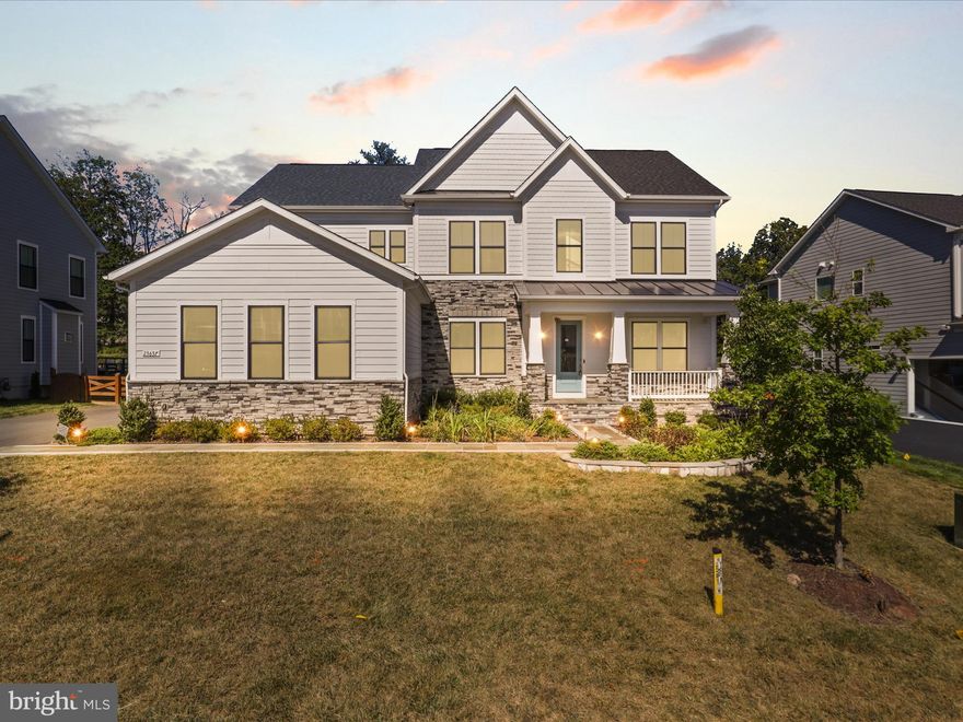 Welcome to the most desirable community in Northern Virginia – welcome to Hartland.  Step inside to the sophisticated DRB Richmond model. Over $200,000+ Worth of Upgrades included. This a modern farmhouse situated on Quarter-acre (1/4) “East Facing”. This stunning home embodies luxury, comfort, and elegance, offering an exceptional living experience for the discerning homeowner. With its impeccable design, craftsmanship, and unparalleled amenities. Situated on a meticulously landscaped lot Backing to woods, This home boasts exquisite curb appeal and an inviting presence. Step inside, and you'll immediately be captivated by the grandeur of the foyer, featuring soaring ceilings and an abundance of natural light. 3 finished levels with almost 6000 finished square feet on two levels, 5 bed rooms and 5.5 baths 3-car Side load garage. The large stone-front porch invites you into a beautifully designed open-concept floor plan, complete with upgraded luxury vinyl plank flooring and exceptional finishes throughout. The main level features a spacious library, a separate dining room. The heart of the home is the gourmet kitchen, beautifully appointed with quartz countertops, floor-to-ceiling cabinetry, custom lighting, and sleek designer touches. Just off the kitchen, the spacious family room features striking coffered ceiling that add warmth, character, and architectural charm. Throughout the home, you'll find luxury vinyl wide-plank flooring on all three levels, elegant crown molding, coffered ceilings, and eye-catching modern fireplaces that elevate each space.. Enjoy easy access from the kitchen/family room to the stunning covered porch, ideal for outdoor entertaining or relaxing and walk down to the stone patio. Upstairs, you'll find 4 spacious bedrooms, 3 full bathrooms, and a separate laundry room for convenience. The large primary suite features a Tray ceilings , dual walk-in closets, a luxurious en-suite bathroom with dual vanities, and a separate two-headed seamless glass shower. The 3 secondary bedrooms are all outfitted with upgraded carpet & 2 additional full baths, and an upstairs laundry room to complete the upper level. The fully finished walkout basement is a remarkable extension of the home’s living space, designed for both recreation and relaxation. A large rec room provides endless possibilities for entertainment and makes hosting effortless. The dedicated media room is perfect for movie nights, and the gym room, allows for convenient at-home workouts. Additionally, the lower level includes a full bedroom w/ a walk-in closet and an attached full bath, making it an ideal guest or au pair suite. An unfinished area provides ample storage. Step outside onto a custom stone patio with expansive backyard and enjoy the serenity of your private backyard oasis. From quiet evenings under the stars to lively summer barbecues, this outdoor space is perfect for making lasting memories with family and friends. Beyond the stunning interiors, this home is further enhanced with an sprinkler system, ensuring lush landscaping year-round. Additional upgrades include , Tankless water heater and furnace humidifier, Fully integrated Security and Monitoring System ,In-Wall Speaker System and Premium Structured wiring, this estate offers an unbeatable location short drive to Old Farm Winery and Hartland Club House.*Premiere Loudoun county schooling*Residents enjoy proximity to picturesque wineries, the expansive Hal and Berni Hanson Regional Park, top-rated schools, premier shopping and dining destinations, and major commuting routes, including Route 50, Loudoun County Parkway, and Old Ox Road. This home is truly a rare gem, offering the perfect balance of privacy, modern luxury and unparalleled convenience.