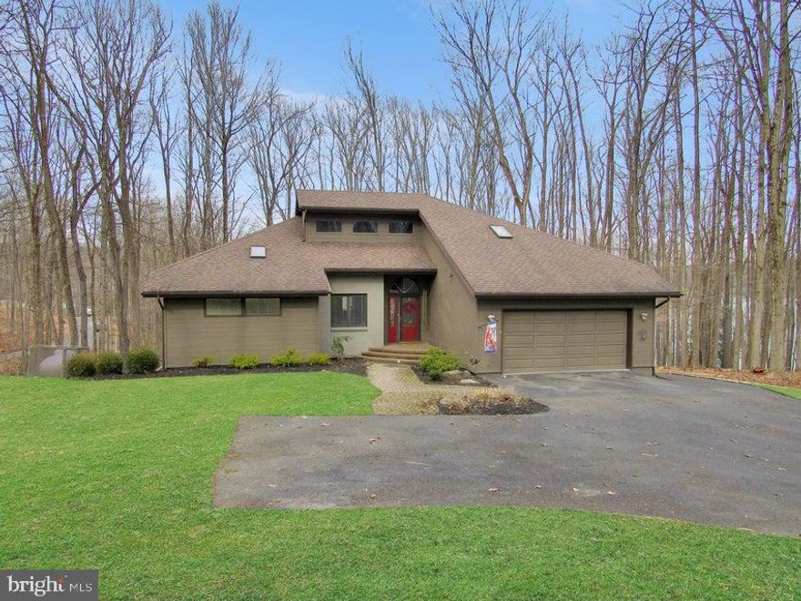 This inviting turnkey Bimini Lake waterfront home is being sold fully furnished, so you can start making memories the day you close. A harmonious blend of comfort and functionality can be found in this ranch home with an open flowing layout. The heart of the home is the captivating great room with a stunning brick fireplace, hard wood floors and vaulted wood ceilings. There is plenty of room to create memorable meals with a gourmet kitchen, boasting granite countertops, a large island, and modern new stainless steel appliances. This space opens up to a screened in porch area and large deck. The open floor plan seamlessly connects the kitchen to multiple living areas, ideal for both relaxation and entertainment. Warm wooden elements add character throughout. A lower level game room provides additional recreational space with a ping pong table and ample seating. The home's 4 bedrooms, 2 guest rooms and 3 bathrooms ensure privacy and convenience for all occupants. The expansive primary bedroom boasts a bayed window area overlooking the lake through the trees and is complete with a spacious main bath. Large windows flood the interior of this stunning home with natural light, creating a bright and inviting atmosphere. The lower level rec room walks out to a large patio area. There are 3 guest rooms and a bathroom as well as plenty of storage room. Wander down the path to Bimini lake and experience peace and tranquility. Cast your line from your very own dock in hopes of hooking the big one or take a dip in the lake. Or, just enjoy the fabulous views of the calming waters. Bimini Lake it the "quiet lake" with motor limitations of 9.9 hp. The resort style community of Treasure Lake is Located just off exit 101 of Interstate 80. This community offers 2 serene lakes for boating, fishing and swimming, sandy beaches, pools, sand volleyball courts, tennis courts,pickle ball courts, and 2 pristine USGA rated 18 hole golf courses . All of this is enveloped in lush green mature trees and wildlife at every turn.