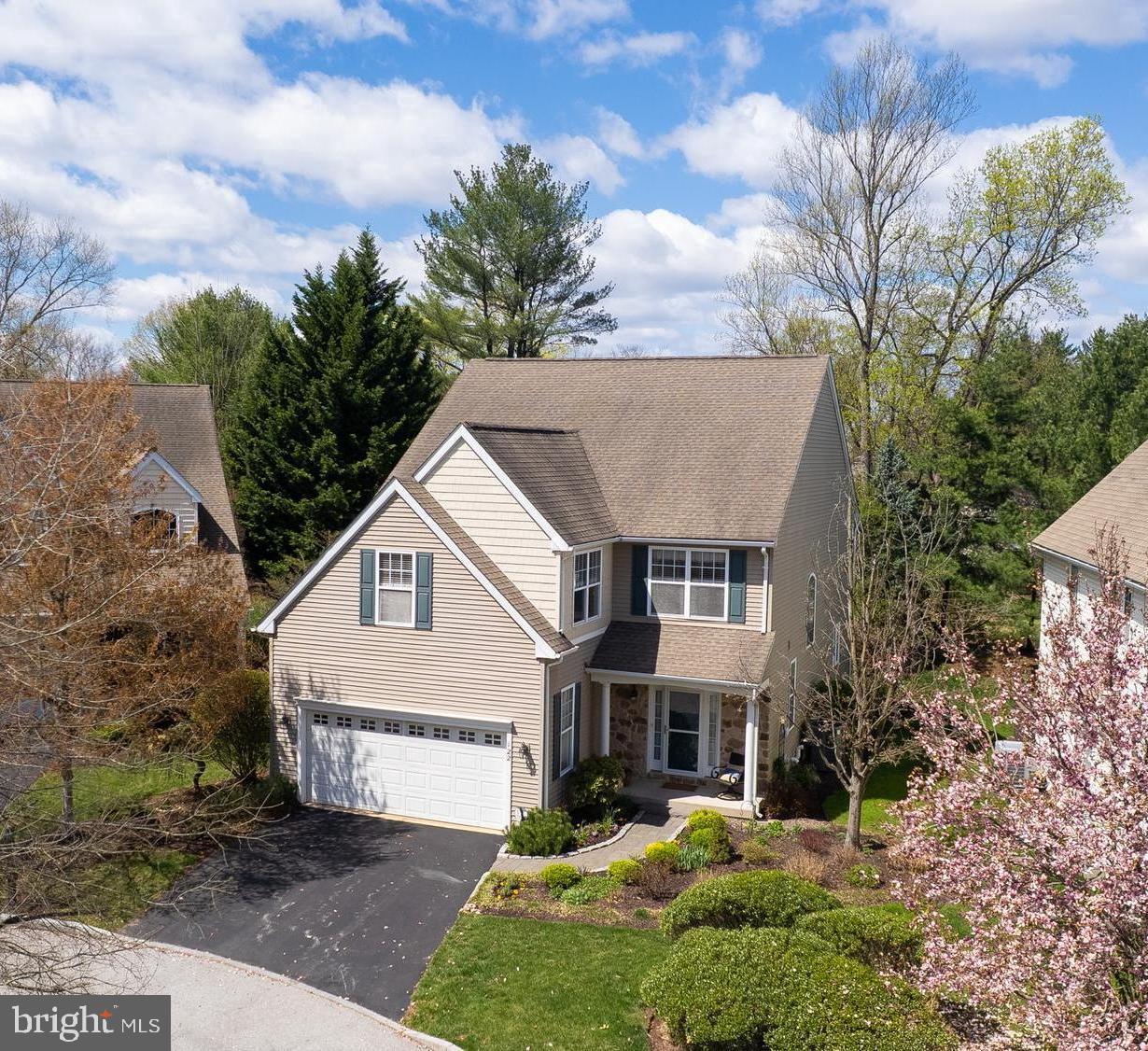 Optimally tucked on a cul-de-sac lot within highly coveted Potters Pond, an exceptional, community-minded enclave of 34 homes that is framed by green space and wrapped by a lovely walking path, this gracious 4 bedroom, 3 full bath, one half bath home provides the very best of Chester County neighborhood living, all within close proximity to vibrant downtown Phoenixville, eclectic Kimberton Village and Valley Forge Park! A curved paver path, lined with Belgian block and professional perennial gardens, leads to the entry. Take in the charming view of the original Potter farmhouse property from the front porch before entering the home through the welcoming foyer that includes a double-doored coat closet, a powder room with marble-top vanity and aged-brass sink, and convenient interior egress to the two car garage. The main level of the home has an expansive open floorplan, with gleaming hardwood floors, 9 foot ceilings, and banks of well-placed windows that provide beautiful natural light throughout the day. The floorplan unfolds from the foyer to the generous dining area, with ample space for large gatherings of family and friends, accented and formalized with gorgeous wainscoting and crown molding. The adjacent living/family room, with integrated ceiling and floor surround sound speakers (included), is warmed by a gas fireplace and flows seamlessly to the kitchen that features a gas range with both a large and small oven, newer Miele dishwasher, built-in microwave and dedicated desk area. Gather around the large granite island for informal dining, or enjoy a meal in the adjacent breakfast nook, with egress to the rear deck and paver backyard areas, and direct access to the walking path. Atop the stairway, which is illuminated by a large, arched window, the primary en-suite is positioned for privacy. Double doors access this sanctuary, with tray ceiling, dual walk-in closets and an oversized bath with walk-in shower, soaking tub, private water closet and dual sink vanity. Three additional well-sized bedrooms can be found down the hallway, along with a full hall bath, and wonderfully convenient upper level laundry room with GE top-load washer, GE dryer, laundry sink and cabinetry. The finished basement is ready for fun with an awesome pool table and accessories included with the property, along with a convenient full bath! You'll be cool in summer and warm in winter with two zones - upper level zone added in 2014 - and thanks to a newer air conditioning system (replaced in 2022) and heating system (replaced in 2019). Outside, find peace and quietude on your back deck and patio, and enjoyment of the professional perennial gardens that wrap the home. Community residents enjoy the walking path to Potters Pond, along with a location that is convenient to shopping, Phoenixville area schools, YMCA and major regional thoroughfares. Come see all that this lovingly maintained home, with carefree living, has to offer !!!