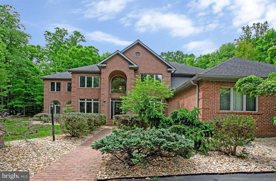 The Ultimate Turnkey Estate: Luxury, Longevity & Leisure
Welcome to a residence where meticulous maintenance meets refined luxury. Set on a private, beautifully landscaped 3-acre lot in the highly sought-after River Hill school district, this exceptional 6-bedroom, 4.5-bath estate has undergone a complete evolution since 2015—blending timeless design with the infrastructure and lifestyle upgrades today’s luxury buyers demand.

From the moment you arrive, the home makes a striking impression with exceptional curb appeal, professionally designed stone landscaping, and a grand wraparound driveway offering abundant parking space for guests and seamless access to the expansive 3-car garage.

The expansive chef’s kitchen, reimagined in 2025, is thoughtfully designed for both elevated entertaining and everyday living. Complete with a sophisticated wine bar and ample space for a large breakfast table, the kitchen serves as the true heart of the home. Rich hardwood floors flow throughout the main level, seamlessly connecting the elegant formal dining room, inviting living room, and spectacular family room.

Anchored by a dramatic stone fireplace that rises to the soaring ceiling, the family room is framed by expansive windows that flood the space with natural light and showcase breathtaking views of the surrounding trees and nature. A Quadratek pellet stove (2022) adds warmth and ambiance to the main living area.

A stunning two-level sunroom further enhances the home’s connection to the outdoors, offering unobstructed views and complete privacy surrounded by mature trees in every season.

The main level also features a flexible bedroom and office suite ideal for guests, multigenerational living, or anyone seeking convenient main-level accessibility without the need to navigate stairs.

Upstairs, retreat to a massive primary suite featuring a wood-burning fireplace, his-and-hers walk-in closets, and a completely redesigned spa-inspired primary bath completed in 2026, offering a luxurious private retreat with high-end finishes and thoughtful design throughout. Three additional spacious bedrooms and two full bathrooms complete the upper level, providing comfort and privacy for family and guests alike.

The fully finished walk-out lower level is an entertainer’s dream and a destination of its own. Designed as the ultimate game and reception space, it features a beautifully remodeled bar area, slate-surface pool table, updated 2023 projector and theater seating, and expansive gathering areas ideal for hosting unforgettable events. The lower level also includes a private bedroom with a large walk-in closet and access to a full bath featuring a private sauna, creating the perfect guest retreat or extended-stay living space. A full mirrored gym with direct walk-out access to the garage completes this exceptional level.
Step outside to your own private backyard resort. Enjoy a heated saltwater inground pool with a new 2024 propane heater, a relaxing deck-side hot tub, professionally designed stone landscaping, and expansive outdoor spaces ideal for entertaining or unwinding in complete privacy. Surrounded by mature trees, the property offers a rare sense of seclusion while still being conveniently located. Just steps from the home, residents also enjoy access to a community tennis court.
This is true turnkey luxury with major investments already completed for peace of mind and long-term value, including:

Landmark Roof (2019)
New Trane Upper-Zone HVAC System (2024)
Liberty Pure Water Purification System (2020)
Hybrid Heat Pump Water Heater (2025)
Professionally Sealed Driveway (2024)
Designed for both luxury living and functionality, the home offers abundant storage throughout, including an expansive 3-car garage with built-in storage solutions. Additional unfinished basement space provides exceptional storage capacity or the opportunity to create future living areas customized to your imagination.
