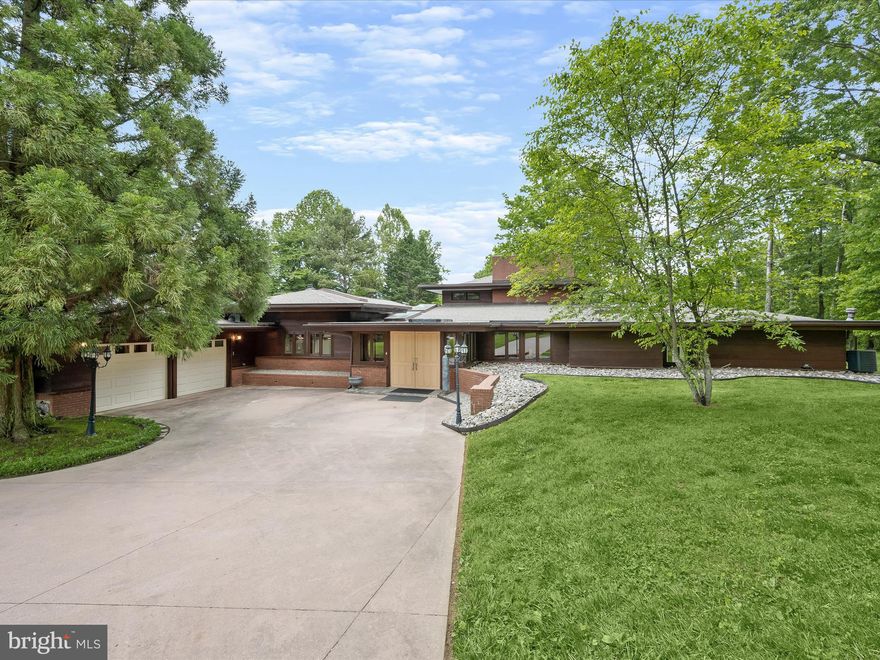 Dipper Willow Estate - A Frank Lloyd Wright Inspired Sanctuary

Prepare to be captivated by the Dipper Willow Estate, a unique Frank Lloyd Wright inspired masterpiece, nestled on 6.8 lush acres in prestigious Dayton, MD. Designed by renowned local builder John Berlin, this future equestrian estate boasts architectural brilliance and an expansive layout ideal for both lavish entertaining and intimate gatherings.

At the heart of this estate is a breathtaking Great Room with soaring 25+ ft ceilings, complemented by a double-sided fireplace and stunning handmade windows that frame the serene outdoor vistas. The indoor climate-controlled lap lane pool, with its bridge leading to the kitchen and master bedroom wing, echoes Wright’s iconic water features, offering a tranquil retreat.

The estate includes a versatile 4-stall barn and guest house, awaiting your vision for renovation, alongside two paddocks and the potential to restore the former riding ring. Your family’s athletes will revel in the current sports field, perfect for soccer, lacrosse, or football, complete with lighting for evening practice.

Car enthusiasts will appreciate the ample storage with a 2-car attached and a 4-car detached garage, the latter offering potential as the ultimate man cave. The property is accentuated by rare mature trees, including an exquisite Redwood Pine, providing a backdrop of natural elegance.

Additional luxuries include Phantom Retractable Screens, skylights, and state-of-the-art pool systems, ensuring modern comfort amidst timeless design.

Located just a short walk from Triadelphia Mill Reservoir and within the Glenelg HS school district, this property is not just a home, but a lifestyle opportunity. Whether you dream of an equestrian estate or a family retreat, Dipper Willow Estate offers a canvas for your aspirations.

Seize the chance to own this one-of-a-kind estate and create your legacy in the heart of Howard County.