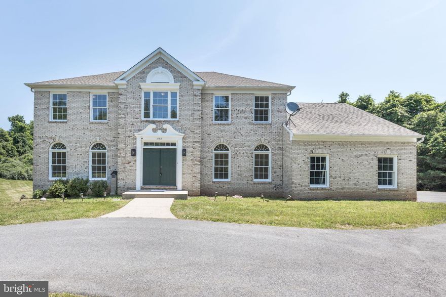 Welcome to your very own secluded retreat in Germantown, bordering North Potomac and Darnestown- just off the I-270 corridor with NO HOA! Beyond a gated entrance, a graceful circular drive guides you to this stunning 4,700-square-foot Colonial brick-front estate, renovated and equipped with a newer water heater (2018), HVAC system (2015) and well water pump (2020). Step through the front door into a soaring two-story foyer, where gleaming hardwood floors welcome you into a spacious, light-filled home office and an elegant living room anchored by an exposed-brick fireplace. The brand-new gourmet kitchen is a chef’s dream, boasting quartz countertops, top-of-the-line appliances and an oversized center island, while nearby you’ll find both a formal dining room and a cozy breakfast nook surrounded by big windows and French doors leading to the wrap around deck. On the main level, you will also find a spacious office with French doors, a powder room, the laundry room, and access to the 2 car garage. 
Ascend the wide staircase to discover your private primary suite—a true sanctuary with dual-sink vanities, a luxurious soaking tub, a glass-door walk-in shower and an enormous walk-in closet. Three additional bedrooms, each with plush new carpeting, share a beautifully renovated full bath. Downstairs, the expansive walk-out lower level invites effortless entertaining or potential In- Law Suite with its large bedroom, full bathroom and convenient kitchenette; French doors open directly onto a wraparound deck framed by two acres of cleared land surrounded by forest-like trees, where deer often wander by at dawn.

Perfectly positioned for families and commuters alike, this exceptional estate offers swift access to the I-270 BioTech Corridor, Potomac Village’s shops and restaurants, community parks and miles of hiking trails. You’re also minutes from Harris Teeter, the Maryland Soccer Plex and the excitement of Washington, D.C. With only one home sold in this enclave over the past year, opportunities like this are truly rare.