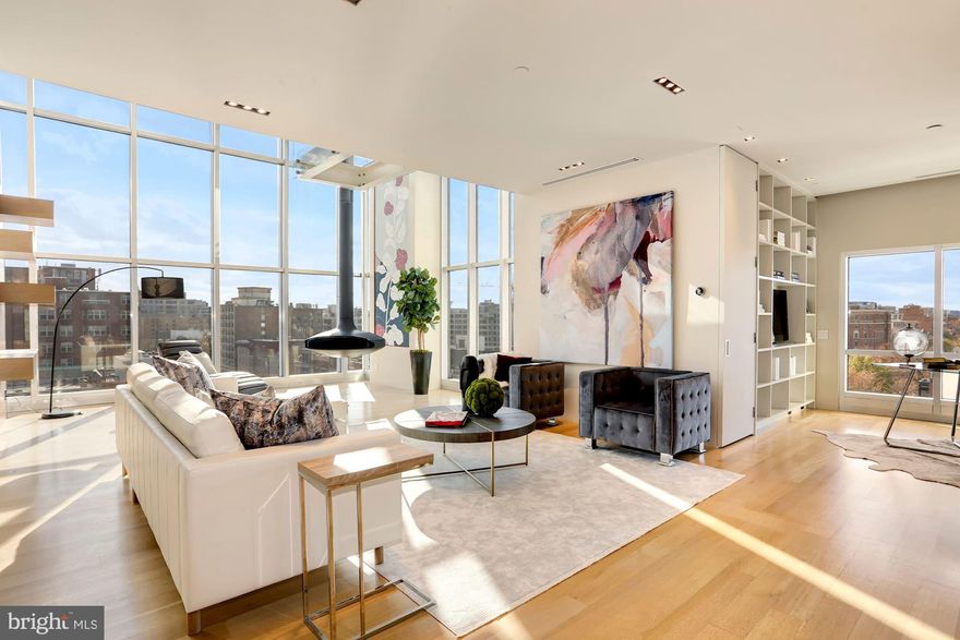 Luxury reimagined with premier penthouse living at The Metropole. Modern living in the heart of Logan Circle in this thoughtfully renovated two bedroom, two bath, two level corner unit. Sweeping views, soaring ceilings, top of the line technology and two private outdoor spaces are just a few things that make this home truly one of a kind. Natural light floods the flowing floorplan of nearly 2,900 finished square feet from the floor to ceiling windows throughout. The gourmet kitchen is fit with a commanding 23-foot island, high end appliances and copious amounts of storage. Overlooking the kitchen is the dining room ready for incredible sit down dinners with a custom iron table, beautiful wall coverings, Murano glass sconces, a gas fireplace and built-ins. Ultimate sophistication meets every day living in the spacious living room with 21 foot ceilings with both south and west exposures. A temperature controlled wine room showcased in glass is fit for a sommelier. A dedicated office space with built-ins and large closet lead to the first bedroom. Mondrian-inspired paneled doors separate this space with a custom murphy bed designed for city living and additional storage throughout. A discreate full bathroom, renovated with Waterworks fixtures, and a separate laundry room and utility room finish off this level. Located on the second floor is the owner?s suite, the perfect blend of sophisticated elegance and open modernity.  The floor to ceiling windows offer Washington Monument views, overlooking both P and 15th Streets. The master bedroom, with a beautifully crafted botanical accent wall as its focal point, also includes a glass catwalk overlooking the lower level, while a sliding door allows for privacy. The suite is further enhanced by a spacious dream-like dressing room, filled with natural light, as well as access to the first to two private green spaces.  The owner's bathroom, recently fully renovated with Waterworks fixtures, offers dual vanities and a spacious shower with even more city views and natural light.  Finishing off the second level, an interior wet bar leading directly to the second private greenspace and a two level roof deck - the pinnacle of outdoor space for prime downtown entertaining.  The outdoor area is perfect for both intimate gatherings and grand parties alike with unparalleled city views. This highly coveted corner unit represents the best of the best in high-end city living.  This property conveys with three secure, designated parking spaces in the building's underground garage, thus the trip from car to front door is just a quick, hassle-free elevator ride.   Additional features include a private storage room, a building concierge seven days a week, secure entry and more.  Pets are warmly welcomed.