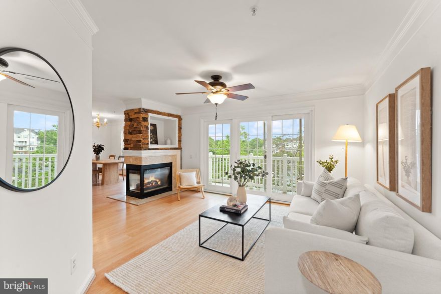 Welcome to 21777 Baldwin Square, a thoughtfully designed two-level penthouse condo in the desirable Chatham Green community. With 1,148 square feet of well-maintained living space, this light-filled home offers an open layout featuring hardwood floors on the main level, a spacious kitchen with a breakfast bar, a separate dining area, and a striking two-sided gas fireplace with stone detailing that anchors the main living spaces. A sliding glass door leads to a private deck overlooking mature trees and beautifully maintained grounds, offering a peaceful and private outdoor retreat. Upstairs, you'll find two generously sized bedrooms, each with vaulted ceilings, large walk-in closets, and en-suite bathrooms—along with a conveniently located laundry room. Freshly painted and move-in ready, this home also includes a newer HVAC system and abundant natural light throughout. Plentiful parking, community amenities including a short stroll to the pool, and proximity to Route 7, Dulles Airport, the Silver Line Metro, and a wide array of shops, restaurants, and parks make this location as convenient as it is charming. With no neighbors above you and every detail in place, this home offers both comfort and convenience for the modern buyer.