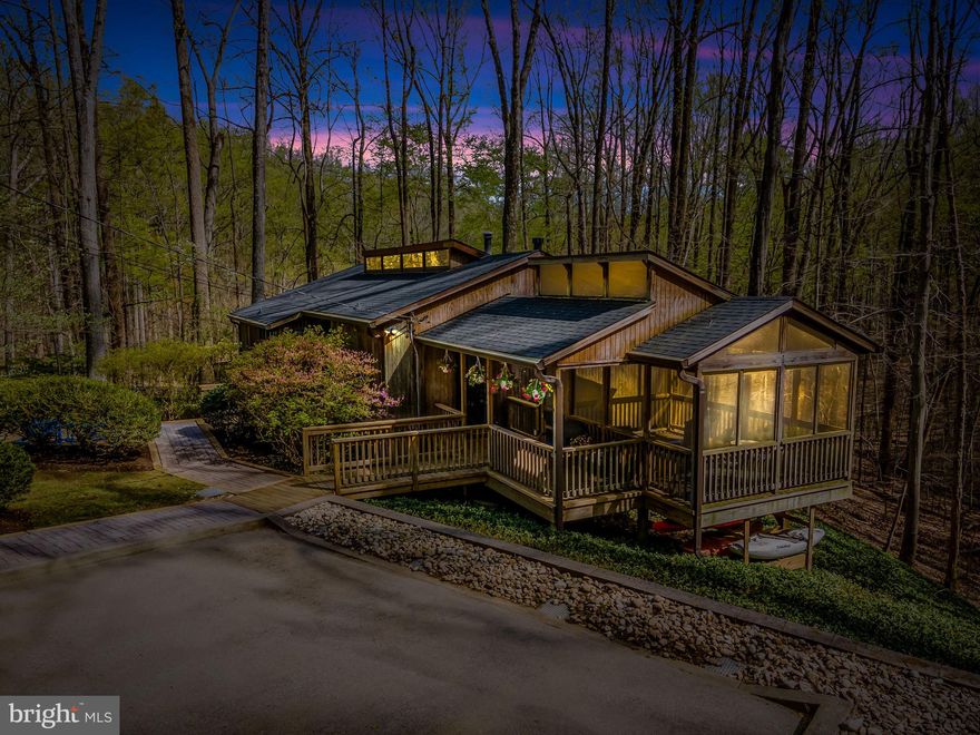 REQUEST FOR OFFER DEADLINE-HIGHEST AND BEST DUE 4/20 AT 3 PM! Architect-designed mid-century contemporary home privately sited on 3.74 wooded acres, blending timeless design with thoughtful modern updates. Located down a secluded driveway, this open-plan home features soaring cathedral ceilings with post-and-beam construction, tongue-and-groove wood ceilings, and clerestory windows that bring in abundant natural light. Expanses of Marvin replacement windows and doors provide serene tree-filled views from every room.

The main level features a spacious Living and Dining area with a freestanding fireplace, an open Kitchen, and seamless access to newly rebuilt decks and a stunning wraparound patio (2023)—ideal for indoor-outdoor living. Refinished hardwood floors (2022) span the main level. The Primary Suite includes updated lighting (2023), and an adjacent bonus room offers flexibility as a home office, laundry, or mudroom. A charming screened sleeping porch adds to the livability.

The walk-out lower level includes a bright Family Room with sliding doors to a grade-level deck, three additional Bedrooms, and an updated full Bath. New luxury vinyl plank flooring was installed in the Kitchen and lower level in 2022. Additional features include art lighting (2023), custom closet systems (2023), and a hot tub (2023).

Enjoy direct access to walking trails leading to Loch Raven Reservoir, offering scenic outdoor recreation right from your doorstep.

Extensive mechanical upgrades include:

Tankless water heater (2024)
Bryant HVAC with major service and new thermostat (2024); system installed 2014 by Pipco
Roof and gutters replaced (2020)
Top driveway resurfaced (2024)
Septic pumped (2024)
New refrigerator and dishwasher (2022)
Dog fence installed (2023)

A custom Rogue Valley raised-panel front door with Baldwin hardware enhances the entry. Driveway parking for multiple vehicles. This special property offers exceptional privacy, architectural integrity, access to nature, and a long list of quality updates—ready for its next chapter.