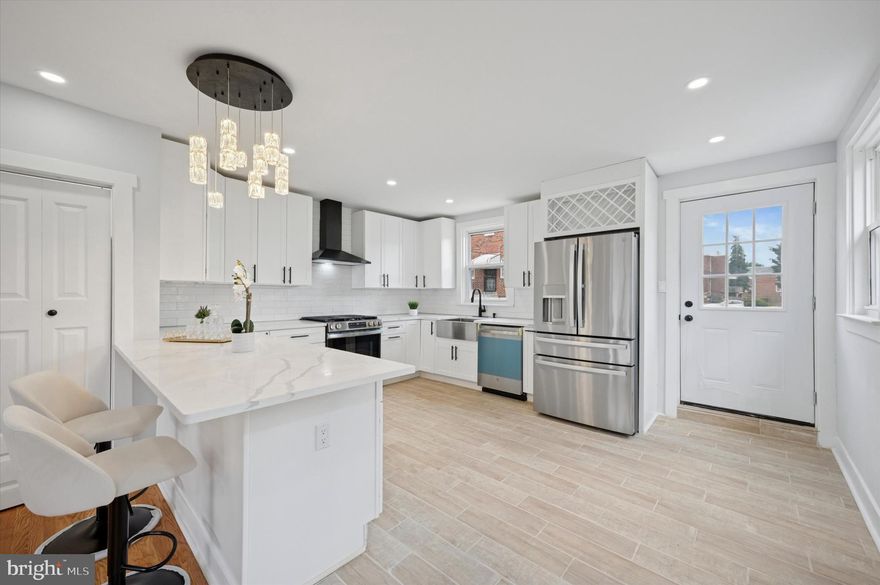 Step into this beautifully renovated 3 bedroom, 4 bathroom home offering a seamless blend of comfort and modern style. The first floor features recessed lighting, a ceiling fan, gleaming hardwood floors, and a spacious half bath. The expansive kitchen is a showstopper with white shaker cabinets accented in black, a subway tile backsplash, a farm-style sink, fridge, dishwasher, and gas range. Off the kitchen you can head outside to enjoy an incredible wood deck, perfect for summer BBQs. Upstairs, you'll find three bedrooms and two full baths. Each bedroom is outfitted with ceiling fans and recessed lighting. The hallway bath is stylish and functional, while the primary suite includes sliding closet doors with an organizer and a private ensuite with a tub shower. The fully finished basement offers even more living space, complete with recessed lighting, engineered wood flooring, illuminated stairs, washer and dryer hookup, a full bathroom with shower stall, and direct access to the rear parking area. Make this home yours today and schedule your tour!