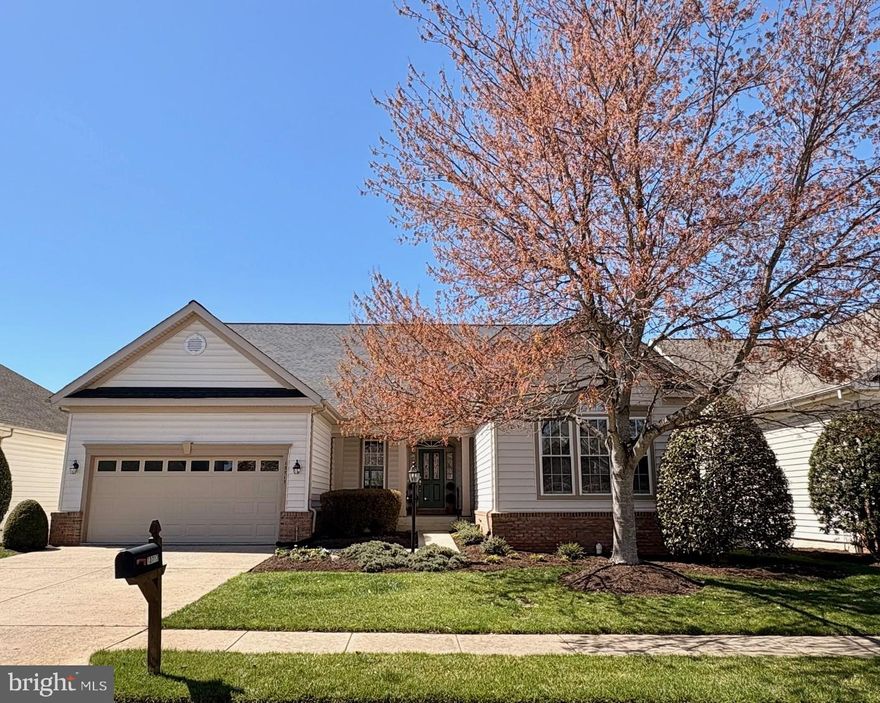 This fabulous Lakemont model sits on a premium golf course lot in the highly desirable gated Heritage Hunt 55+ active adult community in Gainesville, VA, delivering stunning far-reaching views and a true resort-style lifestyle.  The home greets you with a welcoming front porch that overlooks a beautifully landscaped courtyard garden, the perfect spot to relax. Step inside to a gracious foyer featuring a coat closet and tiled flooring. French doors open to a convenient main-level office. The gourmet kitchen shines with rich wood cabinets including pull-out trays, a center island, tiled backsplash, a generous two-door pantry, and recessed lighting. All stainless steel appliances were updated in 2024, including the built-in microwave, stove, dishwasher, and refrigerator. The adjacent breakfast room is bathed in natural light thanks to a large bay window, making it an inviting place to start each day.  The open family room centers around a cozy two-sided gas fireplace, includes a ceiling fan, and offers wonderful golf course views. The living room shares this same warm fireplace, while a bright sunroom lined with windows lets you soak in the scenery year-round. The elegant dining room features an updated chandelier, and neutral paint throughout (refreshed in 2024) along with window shades creates a fresh, timeless feel.
The main-level primary suite is a true retreat, boasting a sloped ceiling with ceiling fan, and dressing area with two walk-in closets. The updated primary bathroom includes granite counter, stylish decorator mirrors, modern lighting, a separate shower, a jetted soaking tub, and a private commode room. A second main-level bedroom provides ample closet space and a ceiling fan, served by an updated hall bath with tub/shower combination. The laundry room is conveniently located on the main level and comes complete with washer and dryer, useful wall cabinets, and a utility sink.
Downstairs, the spacious walkout lower level offers excellent in-law or guest suite potential. It features a large recreation room with its own gas fireplace and direct access to a charming brick patio, a games room with two wall closets, a third bedroom, and a full third bathroom. A practical kitchenette includes granite counters, cabinets, a refrigerator, and sink. There’s also a versatile finished bonus room ideal for a gym, hobby space, or extra storage, plus a dedicated workshop equipped with a workbench, pegboard wall, fluorescent lighting, and a window.
Recent updates keep this home move-in ready: the HVAC system and sump pump with battery backup were replaced around 2025, and the gas hot water heater was installed in 2024. Outside, enjoy the expansive screened porch-complete with ceiling fan and custom shades-for entertaining while taking in the panoramic golf course views. An adjoining deck is perfect for grilling, with stairs leading down to the brick patio below. The professionally landscaped yard includes an in-ground irrigation system. The two-car garage has an updated metal door, and the roof was replaced around 2018.
The HOA covers high-speed internet, cable TV, landline phone, trash pickup, and full access to an impressive array of amenities: an 18-hole championship golf course, fitness center, indoor and outdoor pools, tennis and pickleball courts, clubhouses, walking paths, and more-everything needed for an active, social lifestyle.  Warm, wonderfully maintained, and filled with thoughtful updates, this home is truly move-in ready. Come experience why Heritage Hunt is so beloved-schedule your private tour today!
