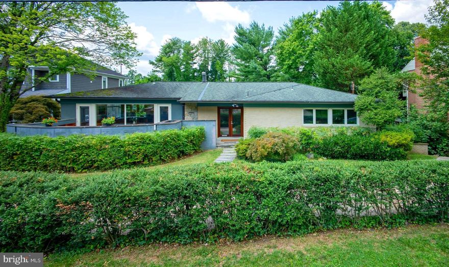 A very special offering in Kenwood Park, this rare and deceptively large 5-bedroom, 4-bathroom Mid-Century Modern jewel boasts nearly 5000 square feet of enticing living space and an array of phenomenal outdoor spaces including a refreshing swimming pool, tiered decks, and unique patios. Complimenting the interior are gleaming hardwood floors, varying ceiling heights with vaulted geometry, and large picture windows which bring the outside in. Highlights of the main floor include all the essentials for one-level living: the first of two primary bedroom suites; an incredible sun filled chef’s island kitchen with walls of glass, a breakfast area, built-in desks, professional appliances, a laundry closet, and access to a wonderful walled patio; a separate dining room with iron railing overlooking the room just below; a relaxing living room offering triple window views of the pool and green setting. A few steps down, the mid-level features a spacious family room with one of two floor-to-ceiling wood burning fireplaces and glass door passage to covered and open decks outside, the second primary bedroom with an attached dual entry bathroom, two additional bedrooms, and a hall bathroom. Predominantly above grade, the expansive lower level offers a kitchenette, a large bedroom, open recreation and game areas, a full bath, and a flexible office space with direct access to a sunroom which runs poolside. A discreet semi-circular driveway, mature plantings, and a fully fenced rear yard with plentiful lawn and gardening space complete the exterior grounds. Endlessly versatile and accommodating, this retreat-style property lends itself to everyday enjoyment, year-round entertaining, and multi-generational living. 6240 Clearwood Road is conveniently located near downtown Bethesda and Washington DC and in the coveted Burning Tree/Pyle/Whitman school districts. Welcome home! (Sq ft & ceiling height calculations provided by Arcdimension/deemed reliable but not guaranteed).